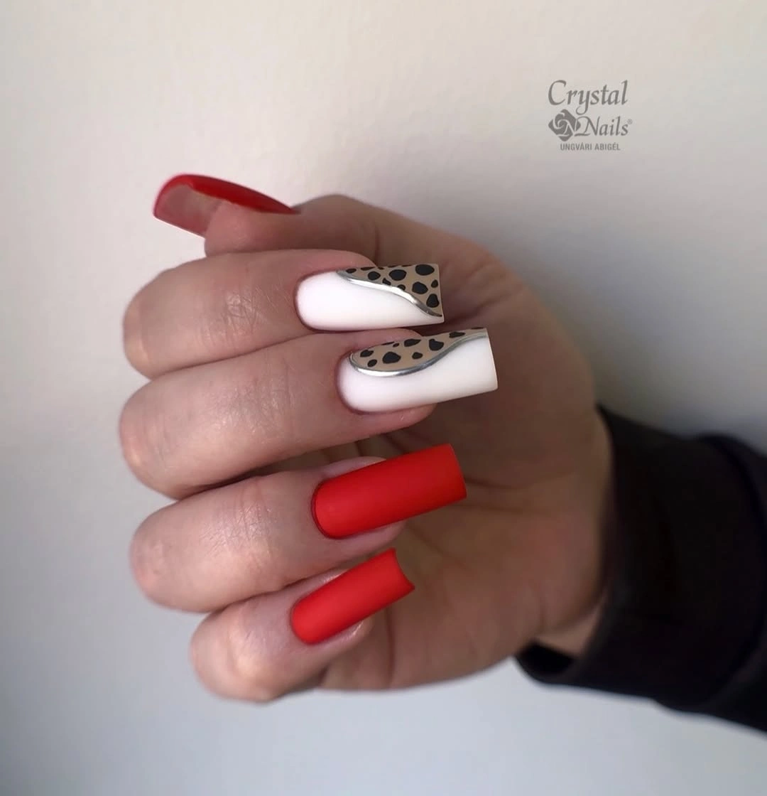 Long square red orange nails with black spotted white tips