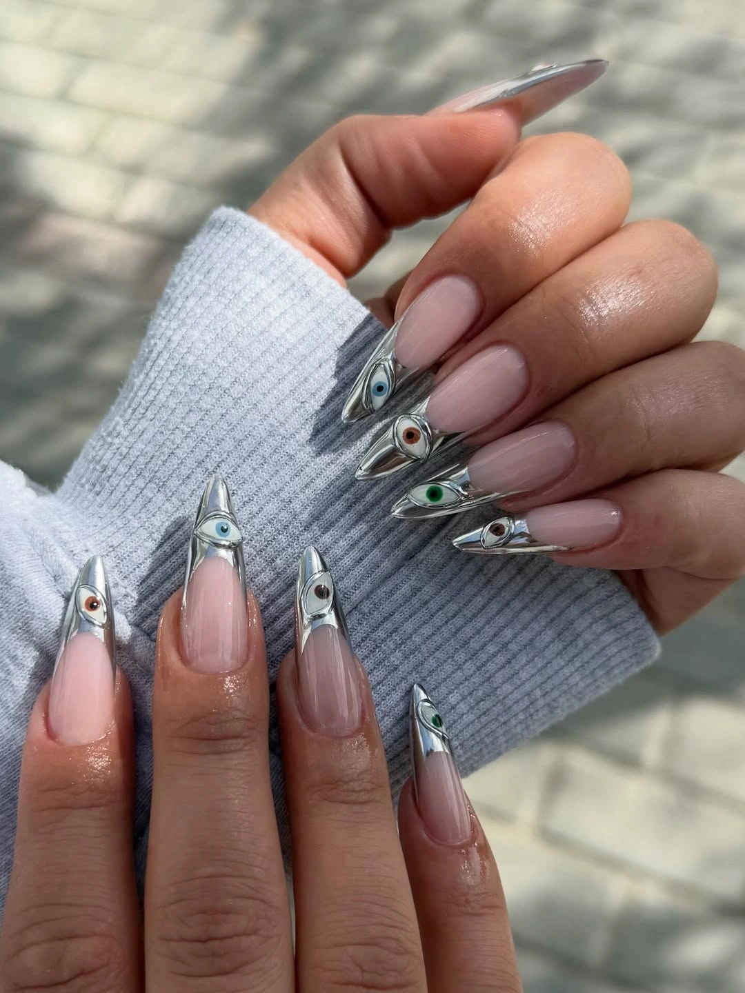 Long almond nude nails with silver triangular French panels