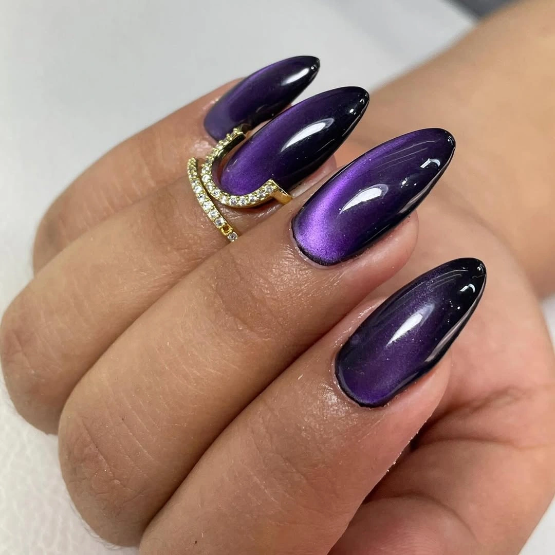 Long glossy deep purple almond nails with reflective depth