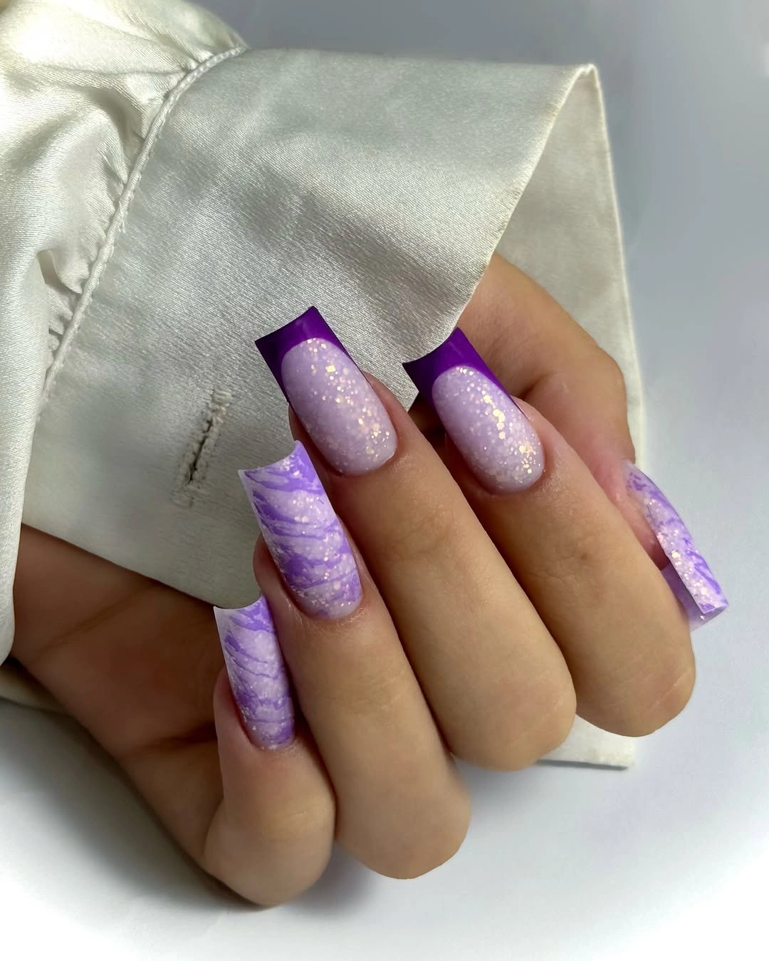 Long square lilac nails with glitter centers and purple tips