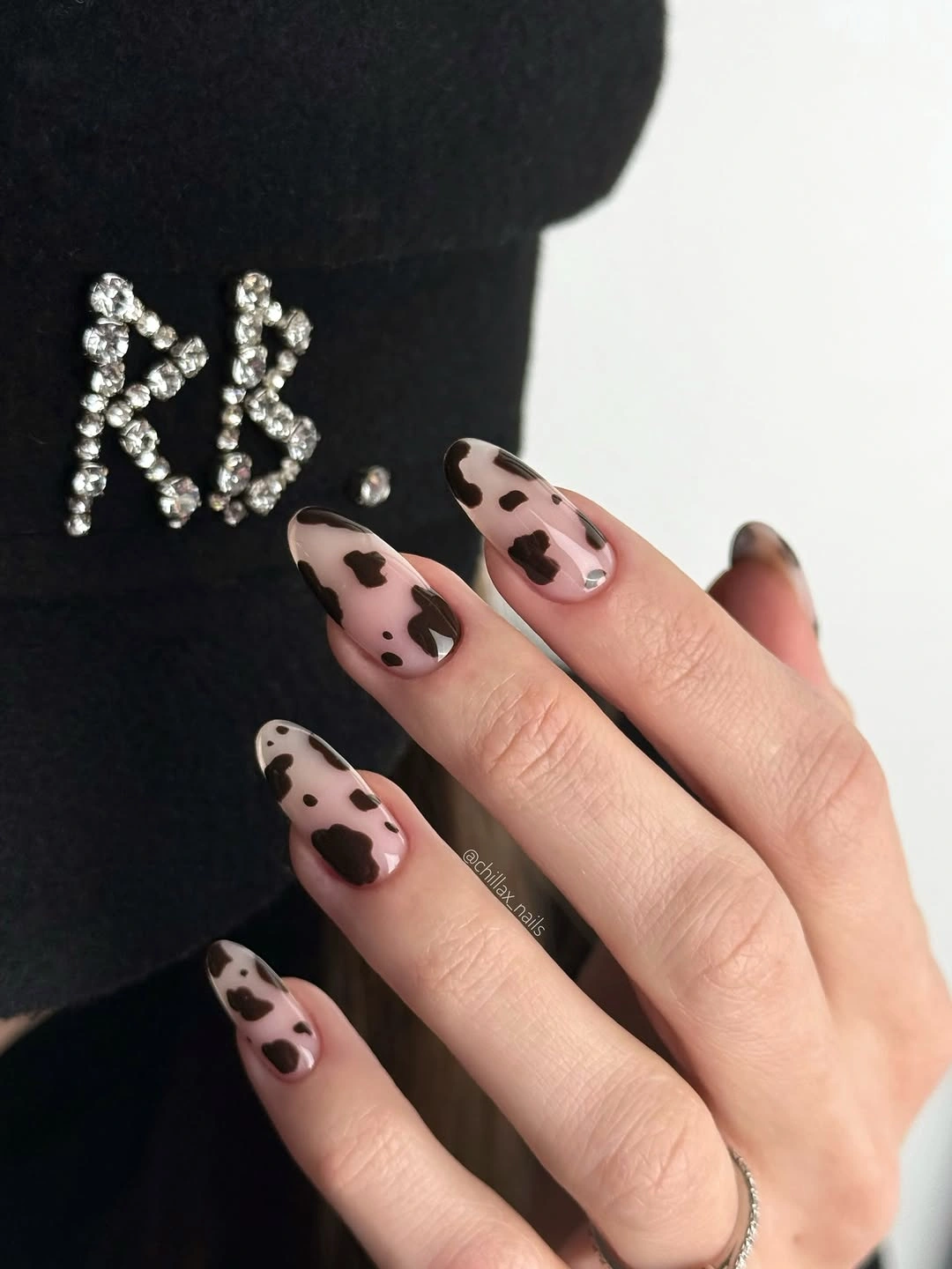 pale pink almond nails with separated dark spotted accents