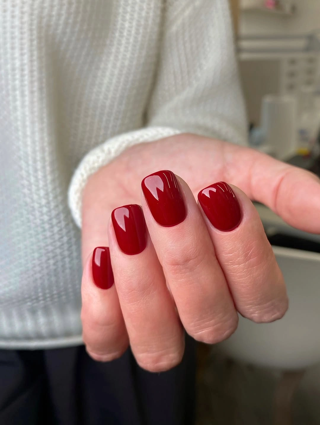 short rounded-square nails in a vivid glossy cherry red