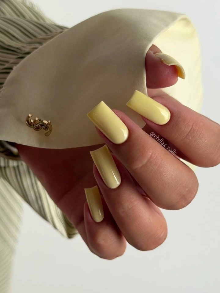 soft butter-yellow nails on a clean medium-long square shape