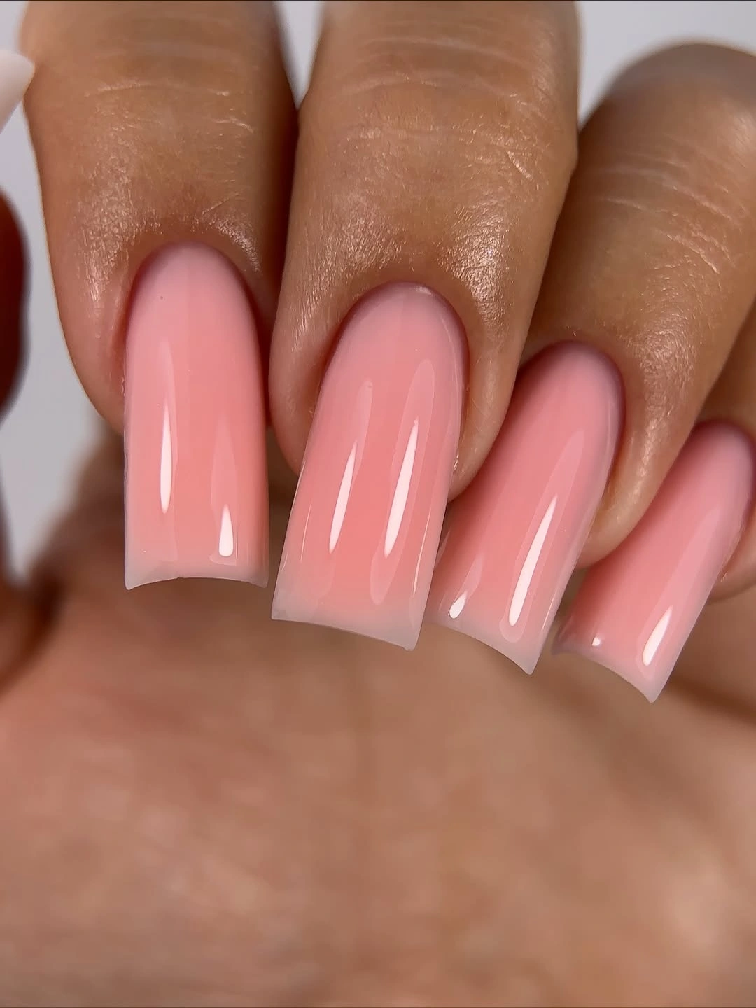 long square nails in a soft translucent pink gloss