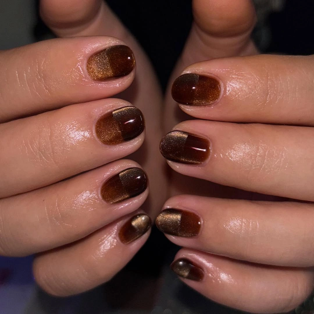 Short rounded brown nails with warm bronze shimmer