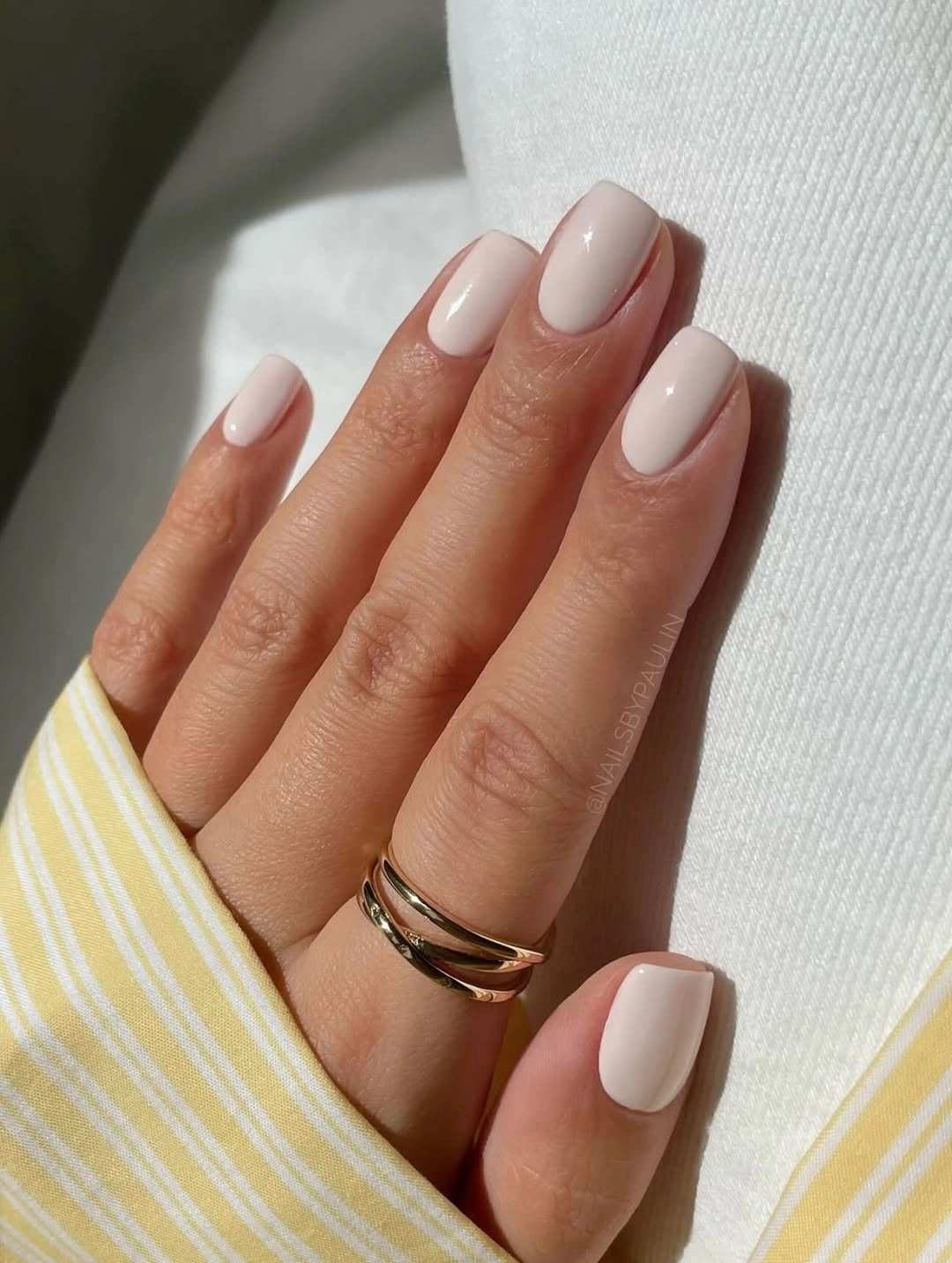 Short rounded square nails in a glossy creamy white shade