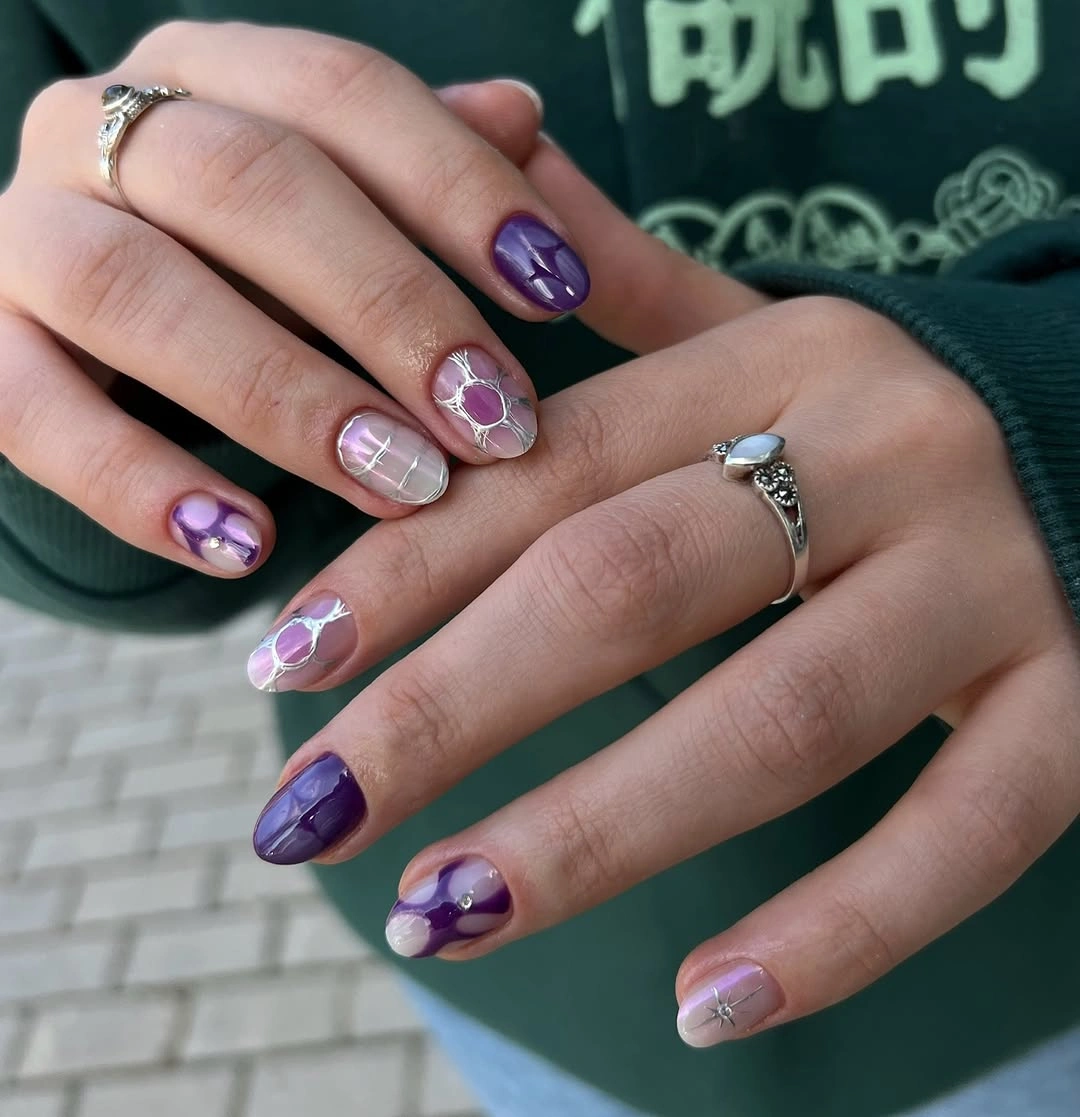 Mixed purple lavender nails with marbling and metallic accents