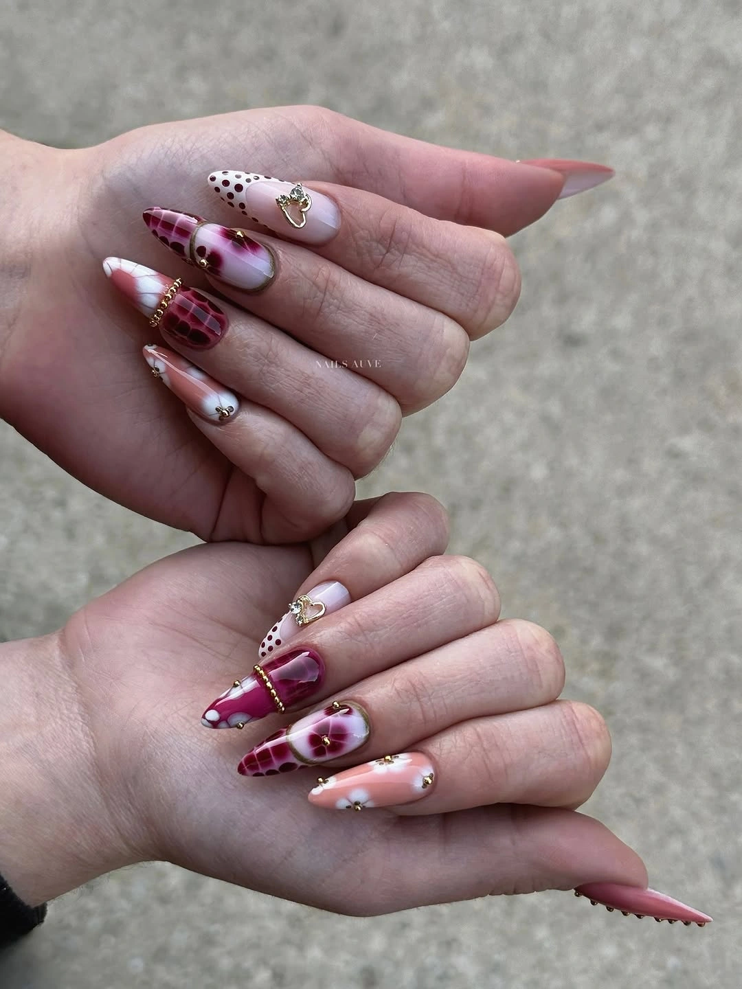 Long pointed nails with burgundy white black and gold details