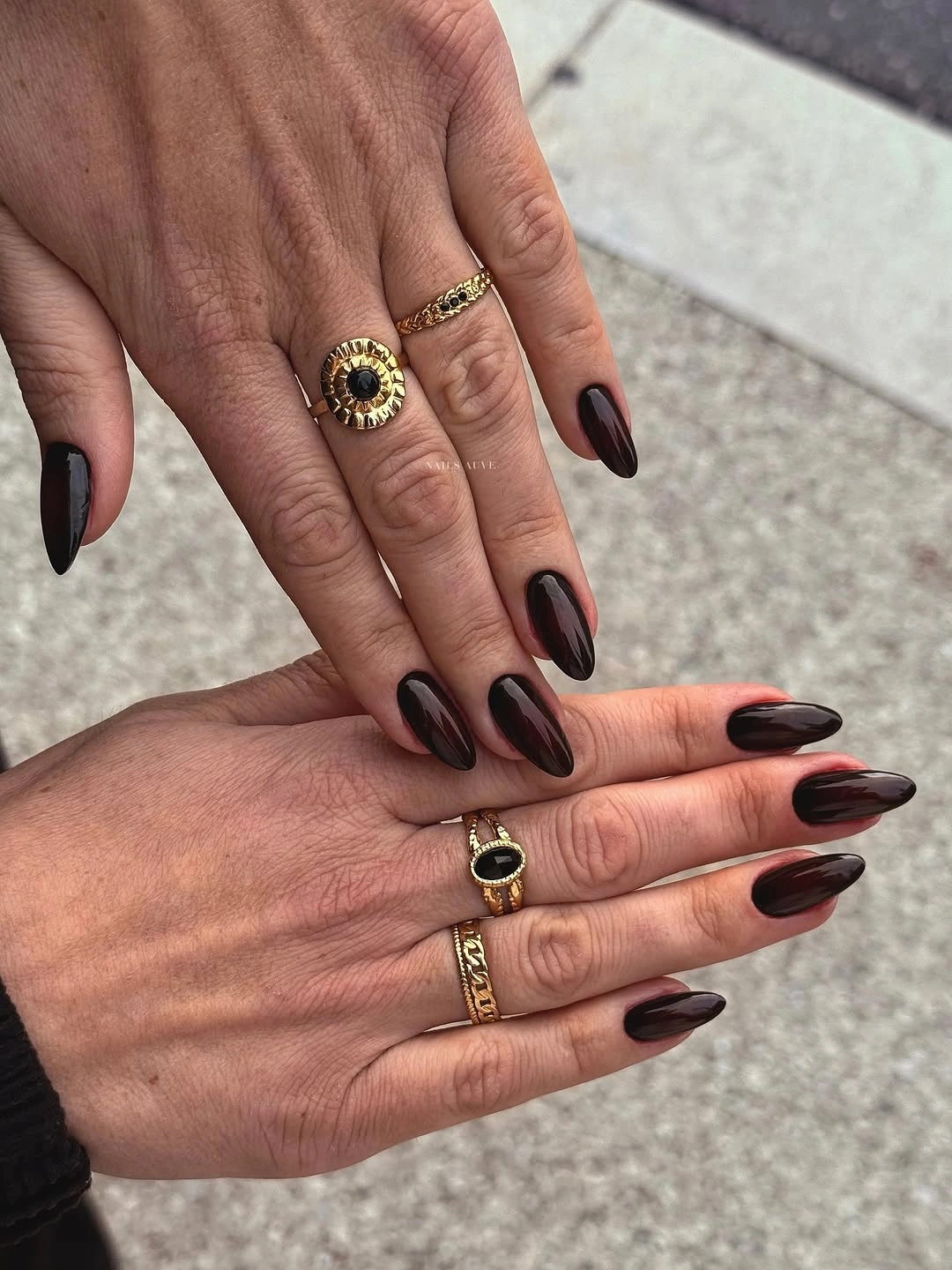 Glossy dark brown almond nails in a monochrome finish