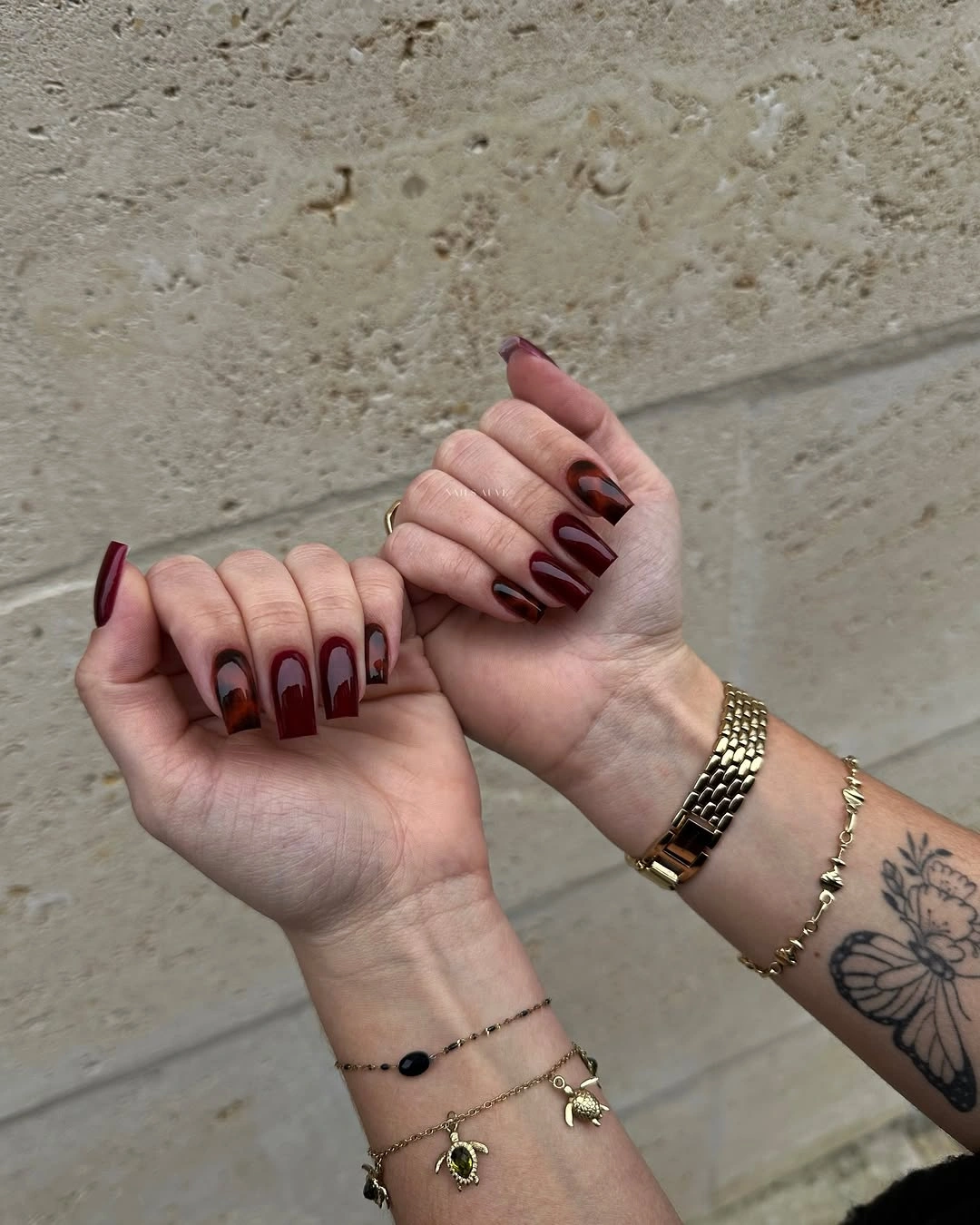 Medium square burgundy nails with warm layered tip panels