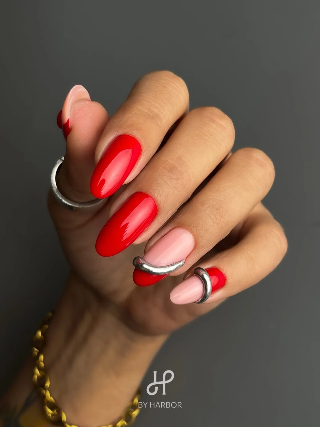 red rounded-square nails with pale black and white curved accents