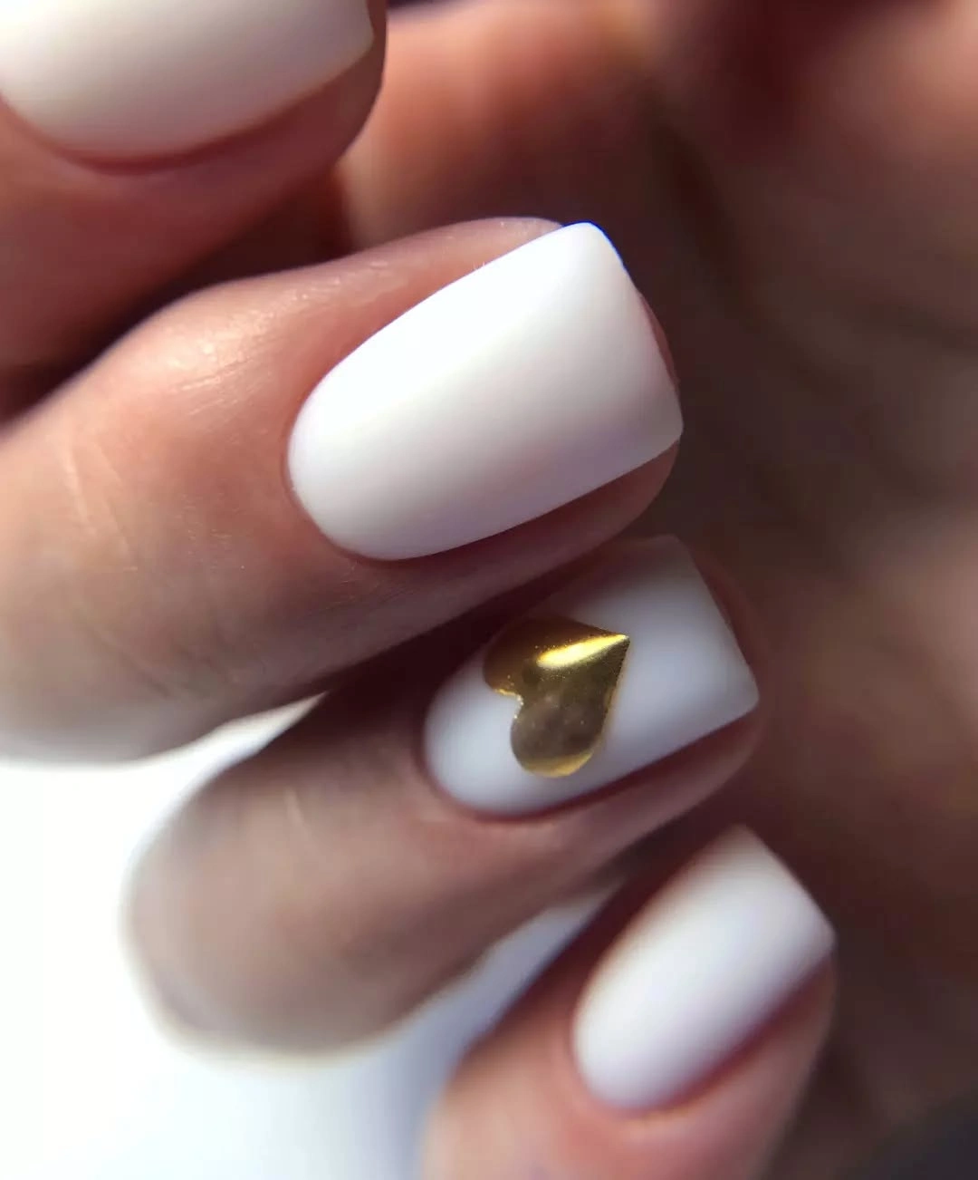 soft white short nails with one tiny gold-looking accent