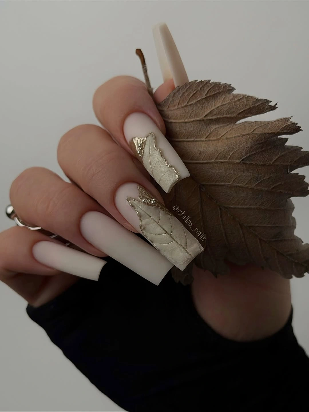 long ivory square nails with taupe panels and gold accents