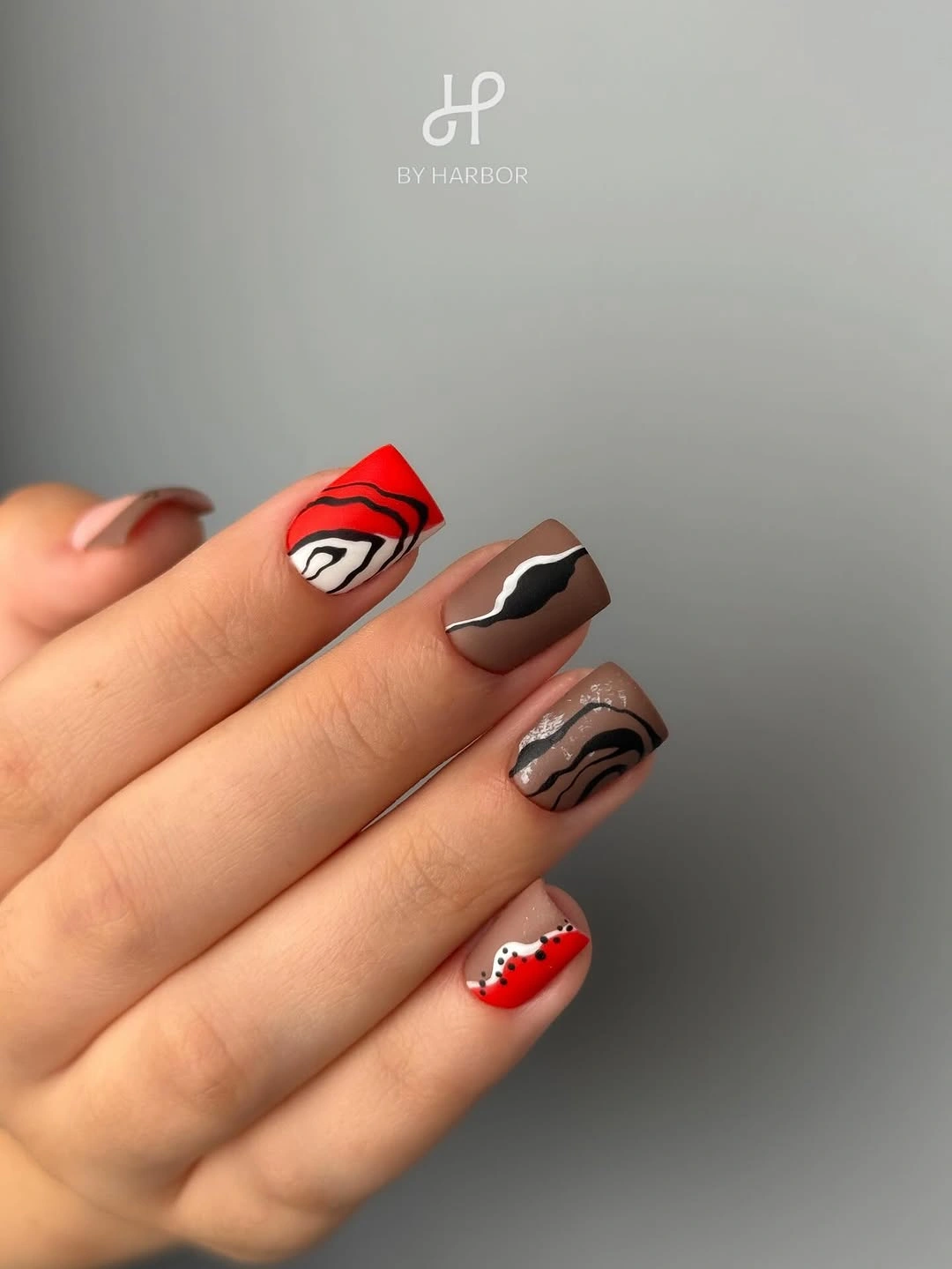 Short square nails with brown red cream and black wavy lines