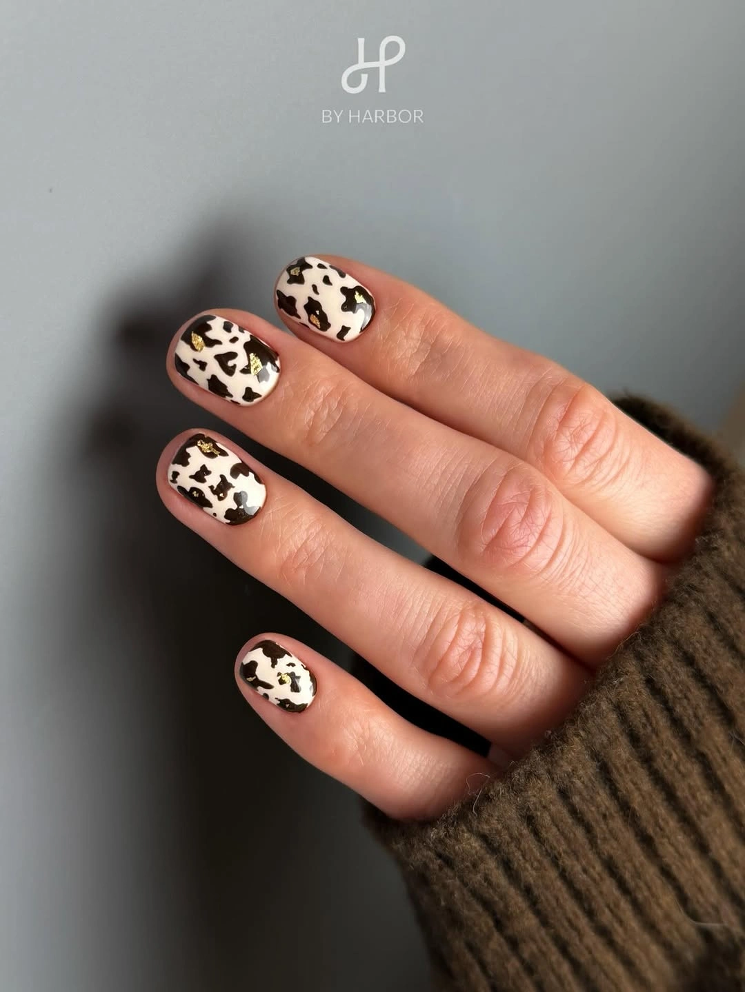 Short white square nails with irregular black and brown spots