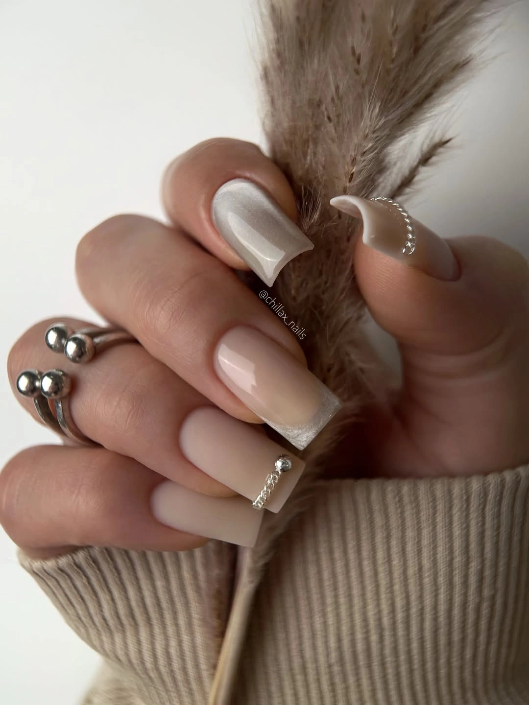 Long nude square nails with pale tips and silver accents