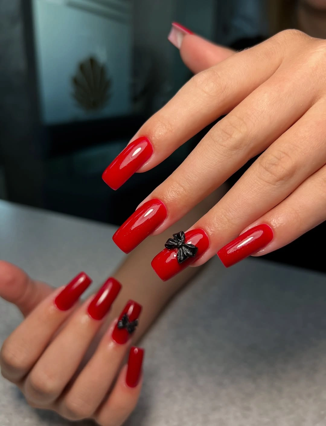 long red square nails with black bow accents