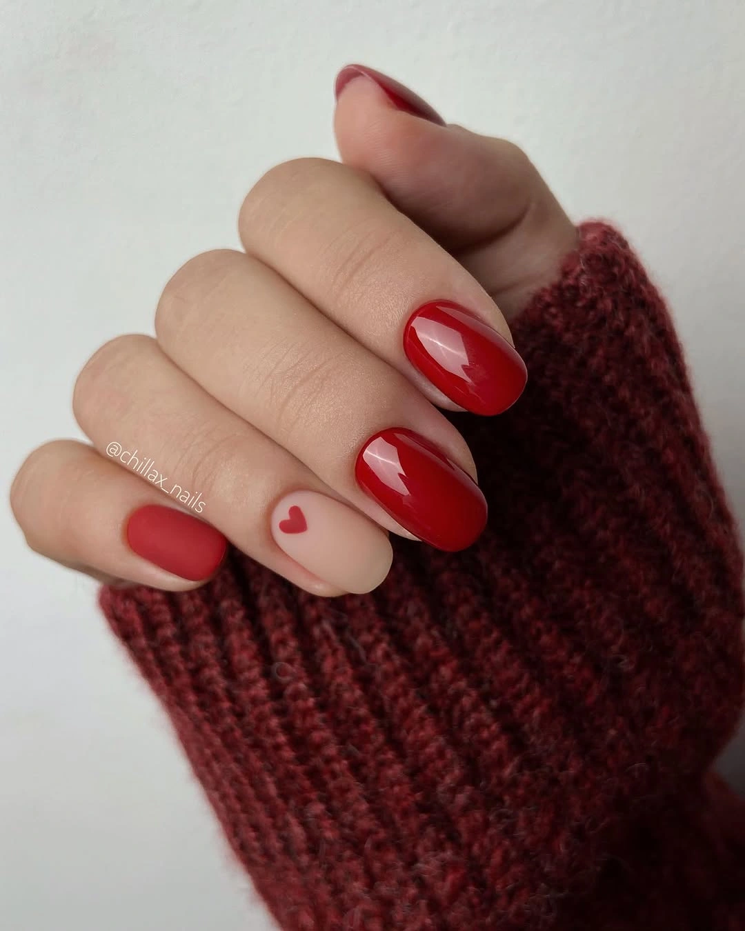 rounded red nails with matte heart accent