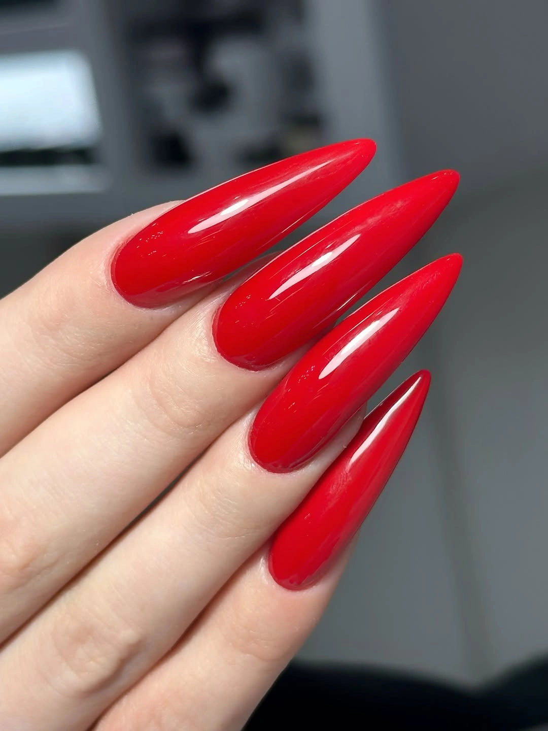 long scarlet almond nails with glossy shine