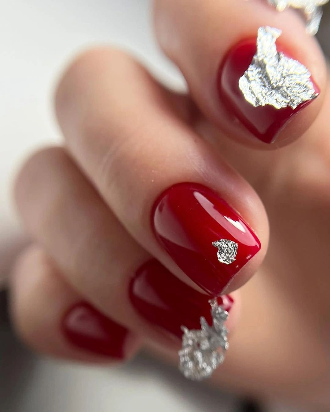 short burgundy nails with silver foil accents