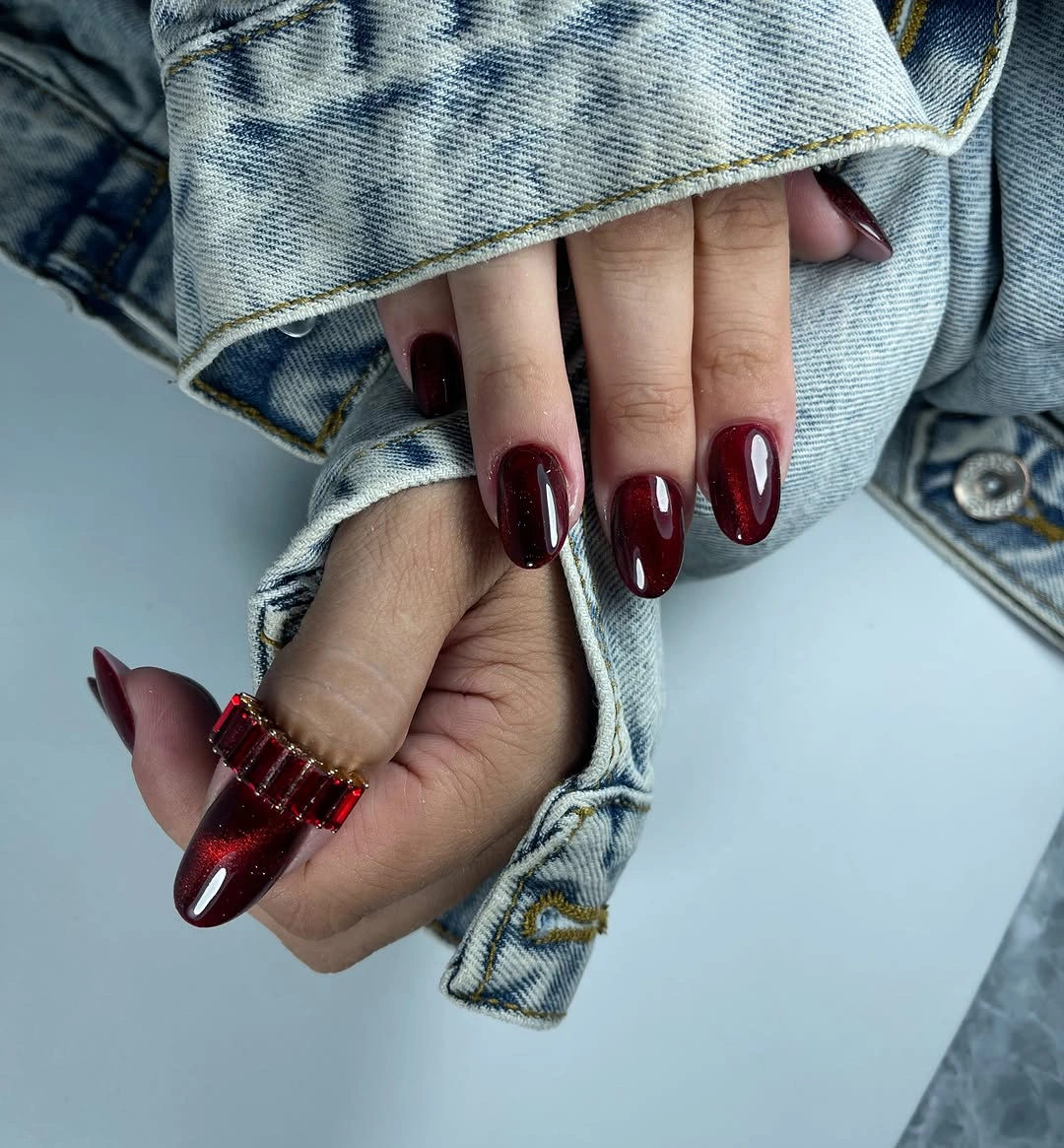 dark cherry almond nails styled with denim