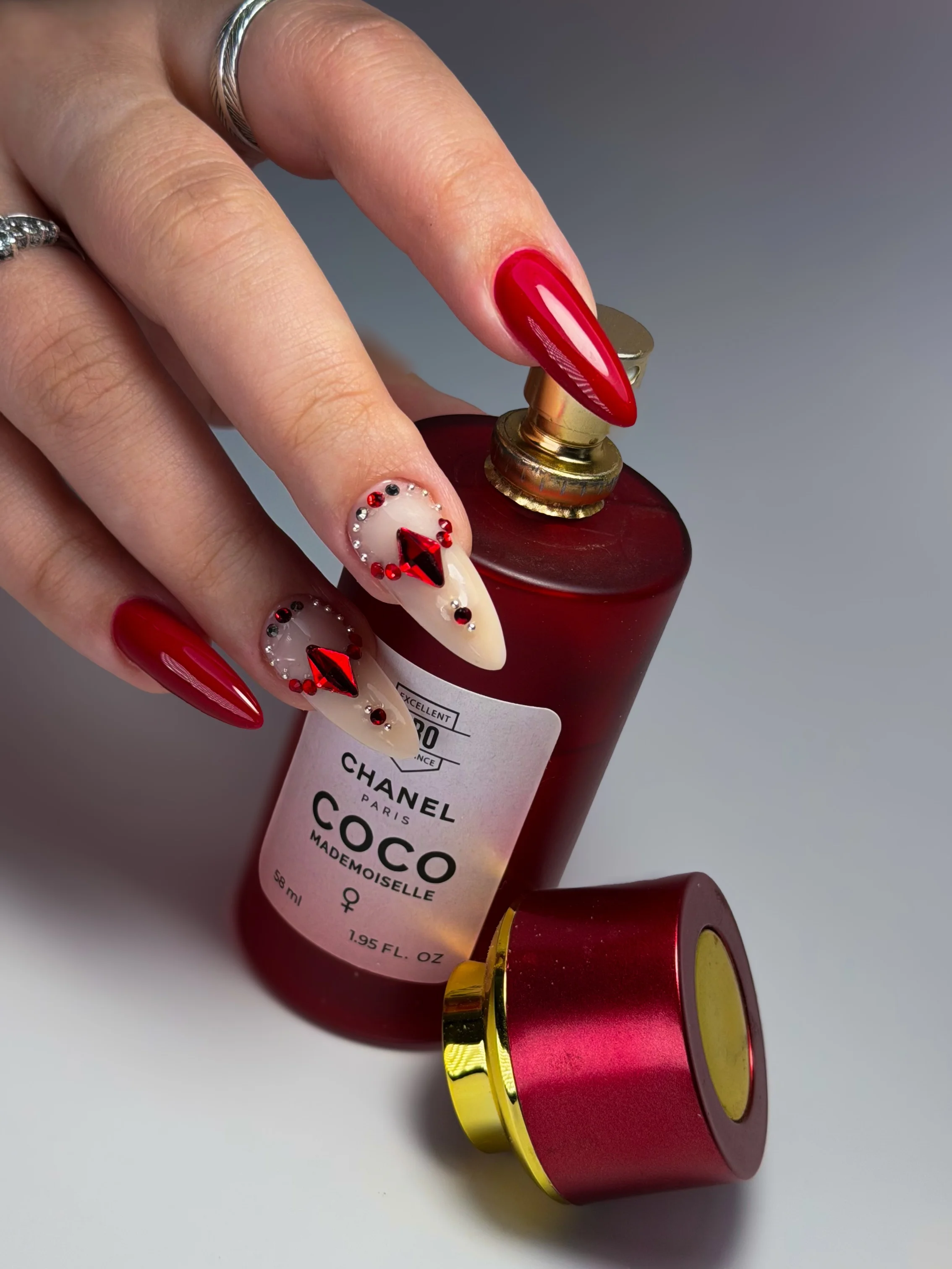 red almond nails with gemstone accent art