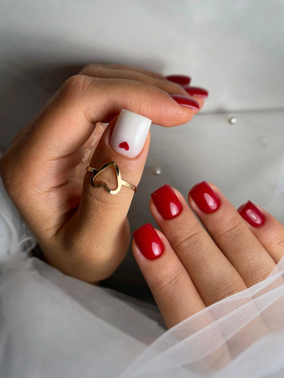 short red square nails with white heart accent
