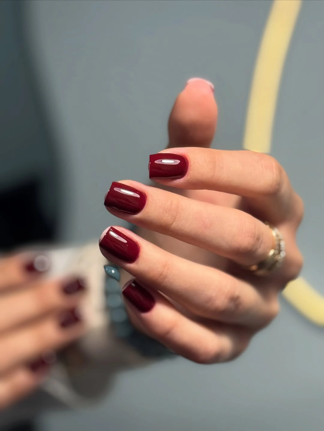 short burgundy square nails in sunlight
