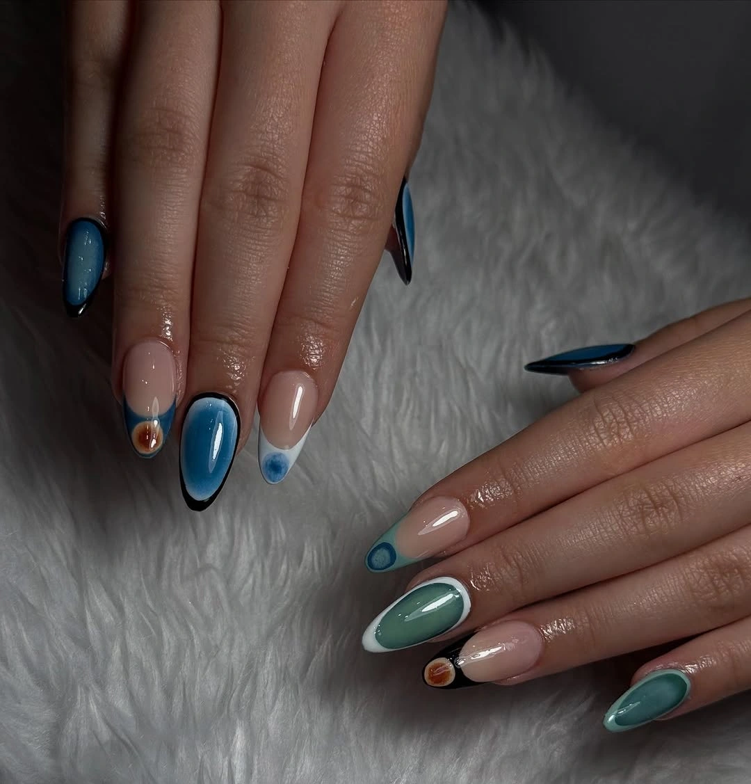 Short almond nails mixing deep blue teal nude and warm dots