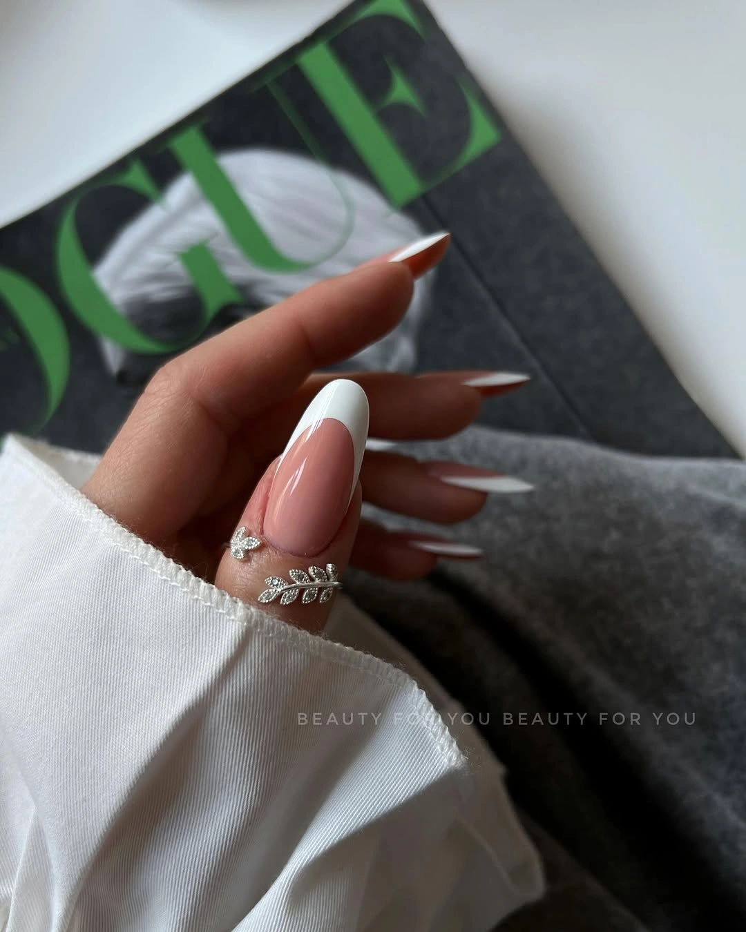Sheer nude almond nails with one hot pink wavy accent