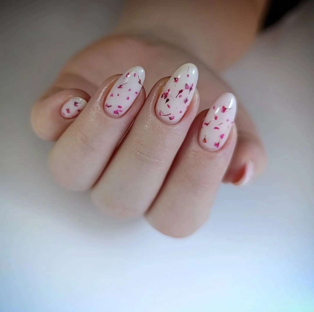 Short black and nude almond nails with leopard spot accents