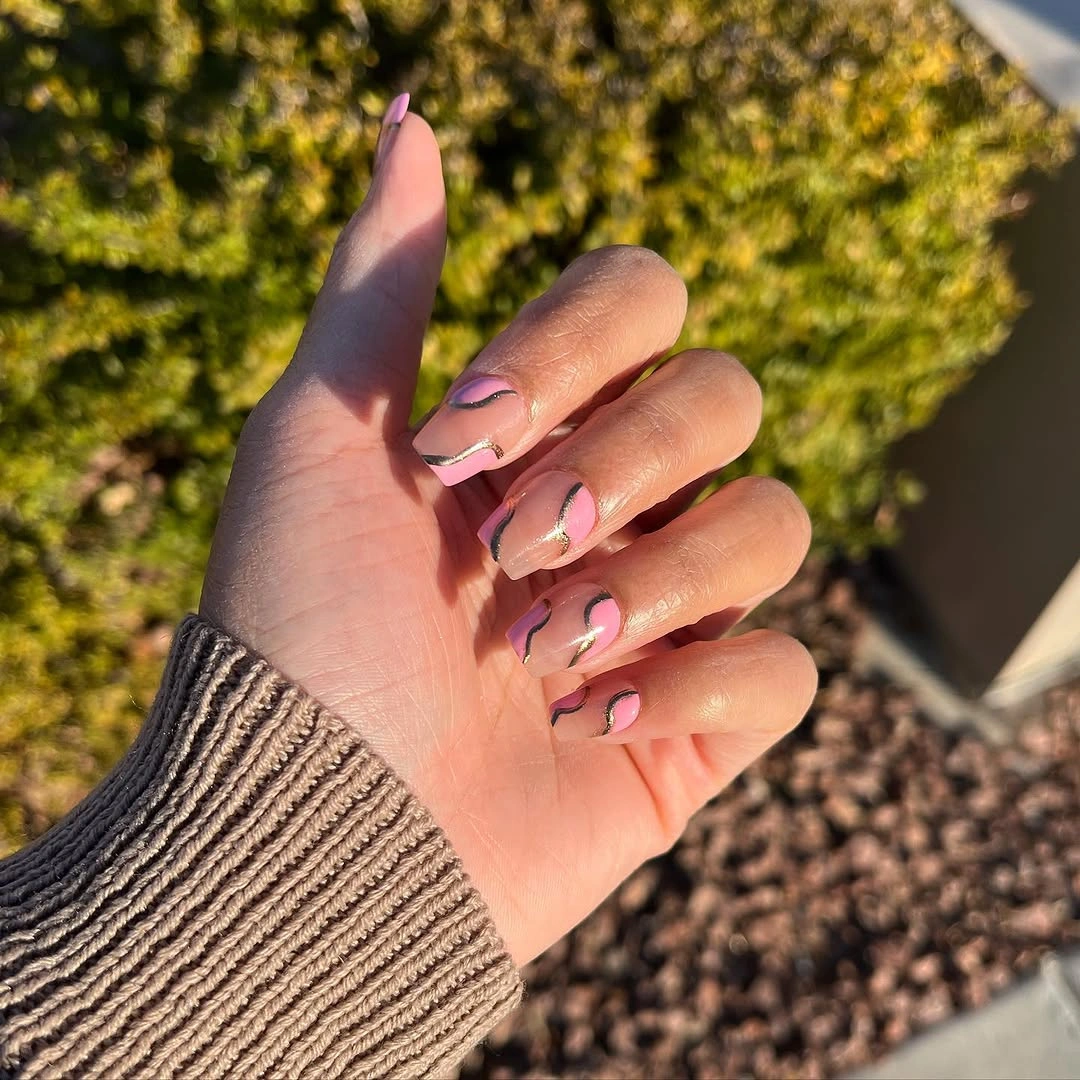 Medium almond nails with soft pink and muted curved accents