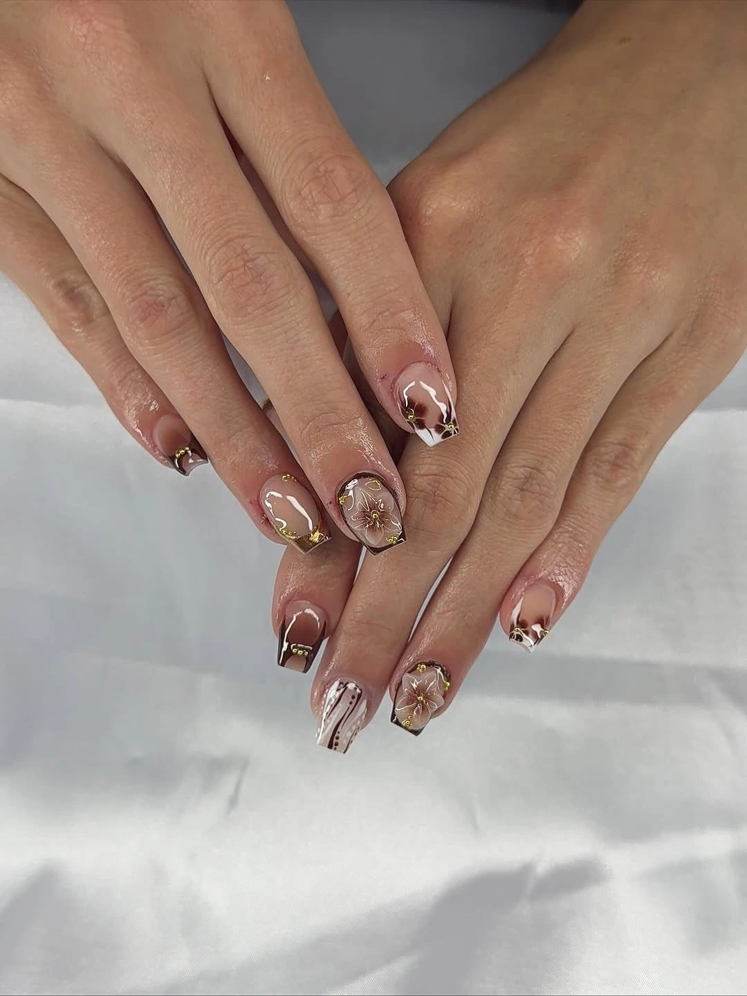 Medium almond blush nails with small warm framed accents