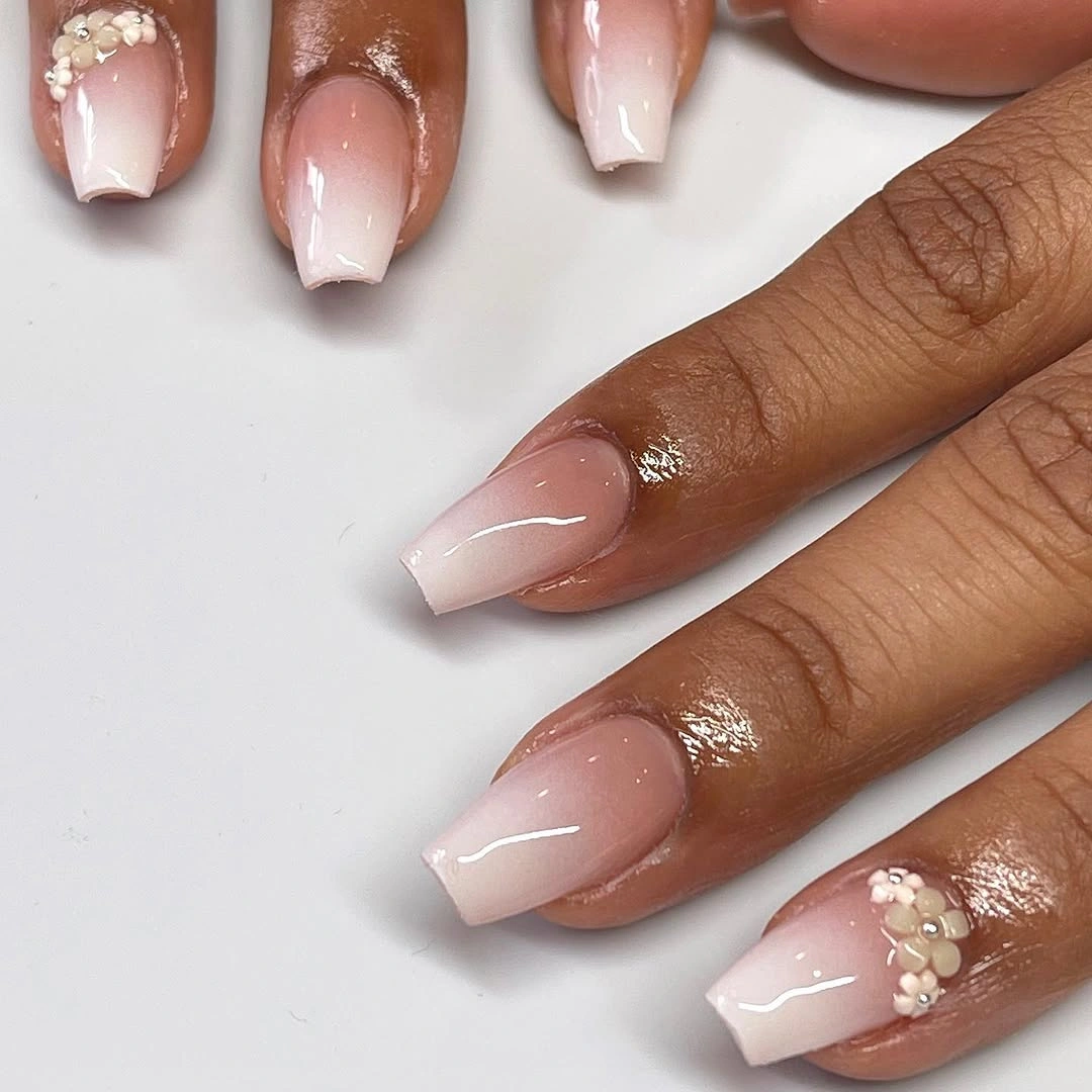 Short square sheer pink nails with thin white tips and one accent
