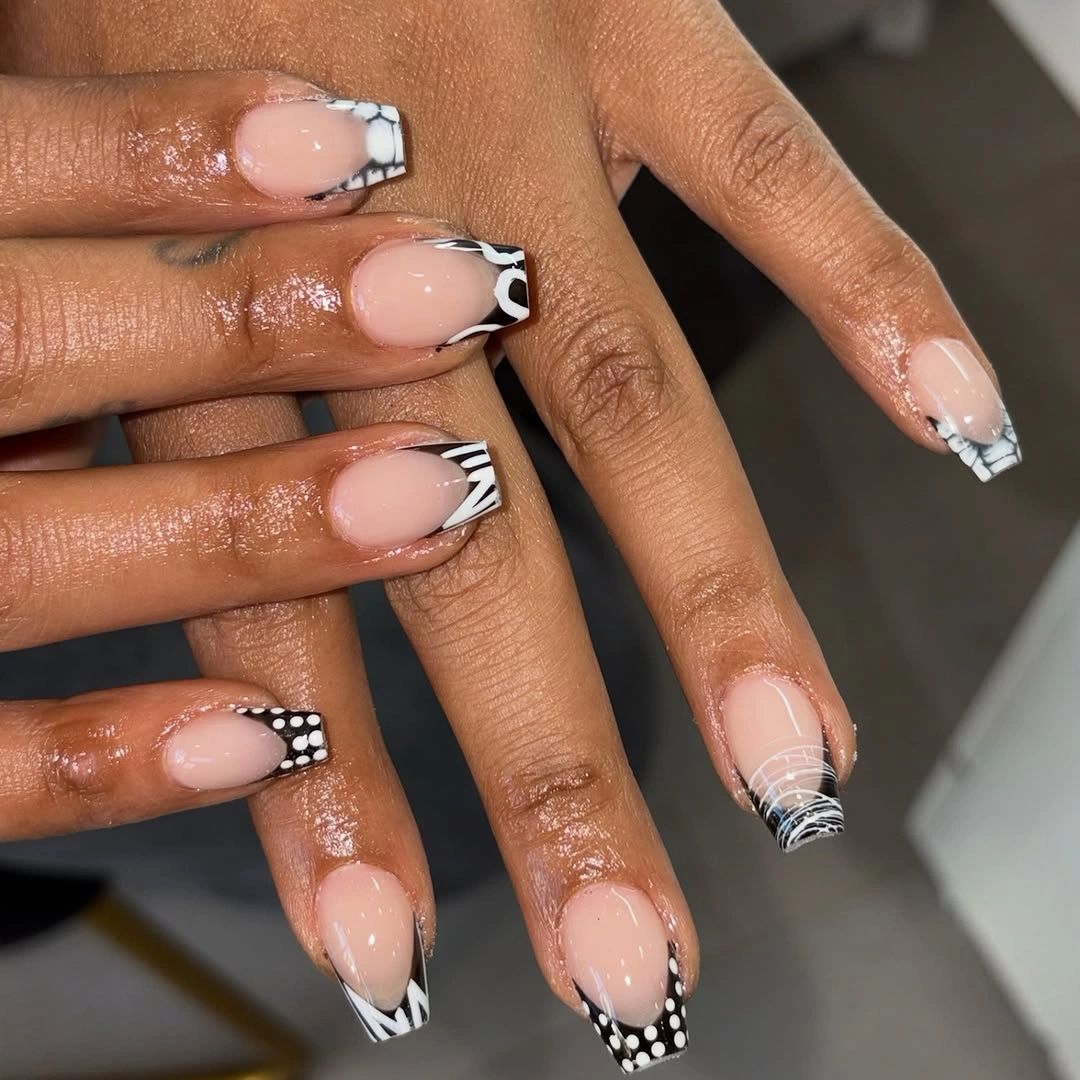 Medium almond nude nails with black and white checkerboard tips