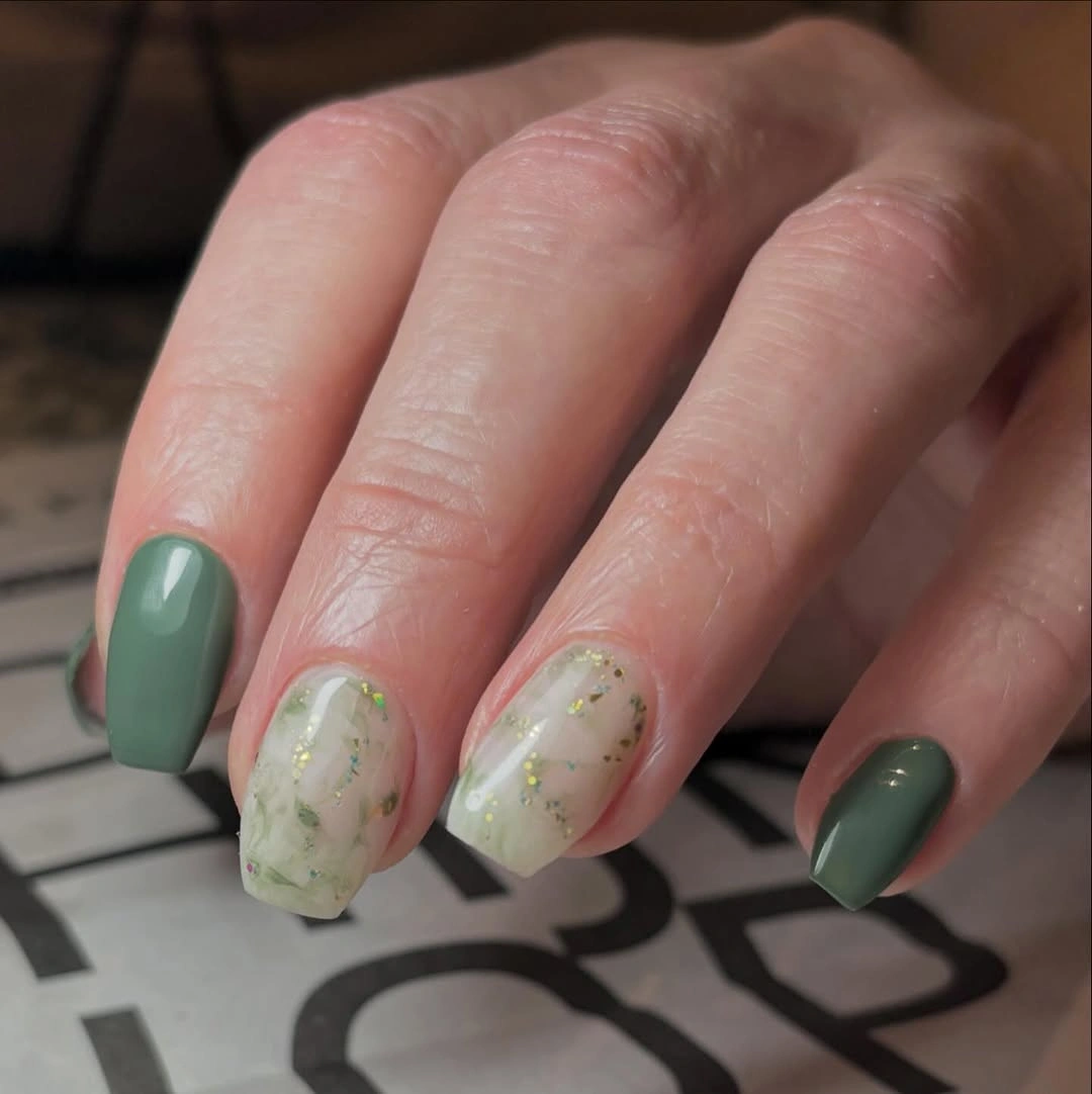 Short rounded square sage nails with milky green marbled accents
