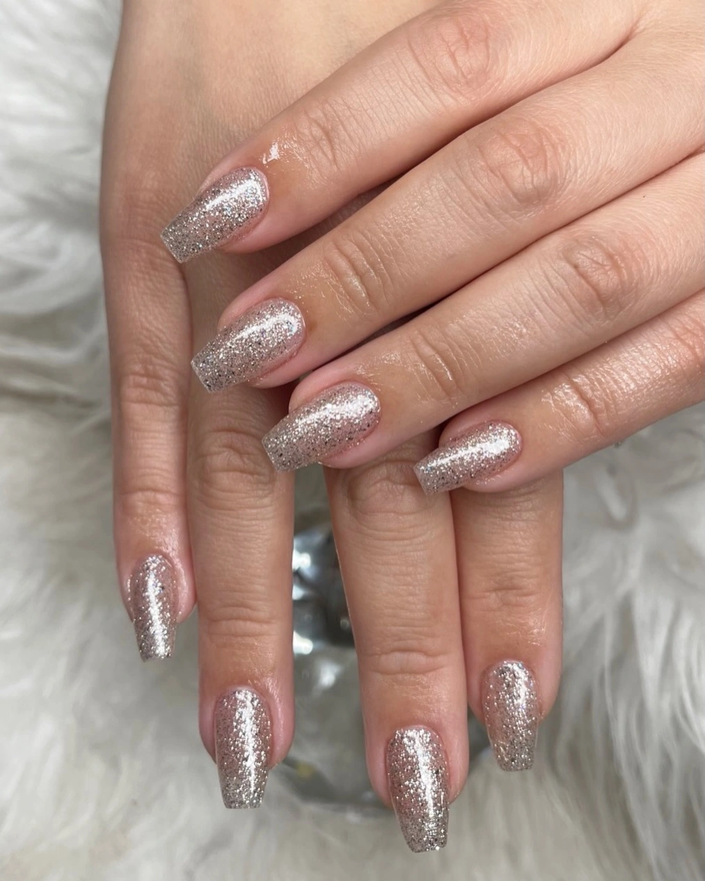 Medium tapered square nails covered in fine silver sparkle