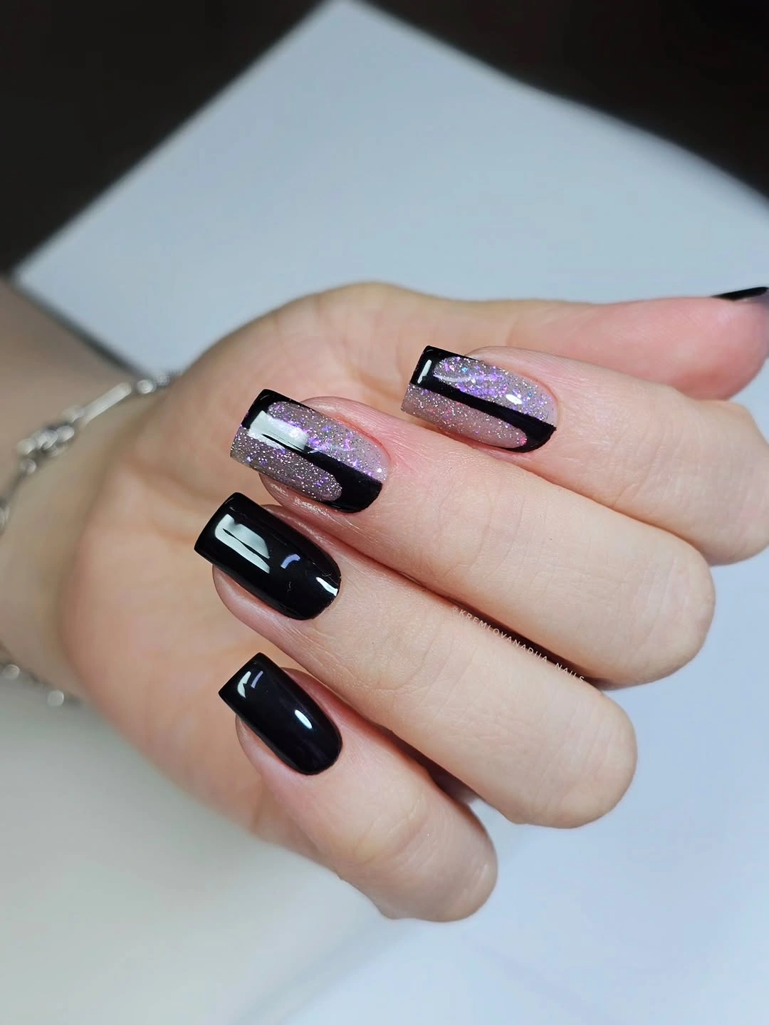 Medium square black nails with reflective pink blue accents