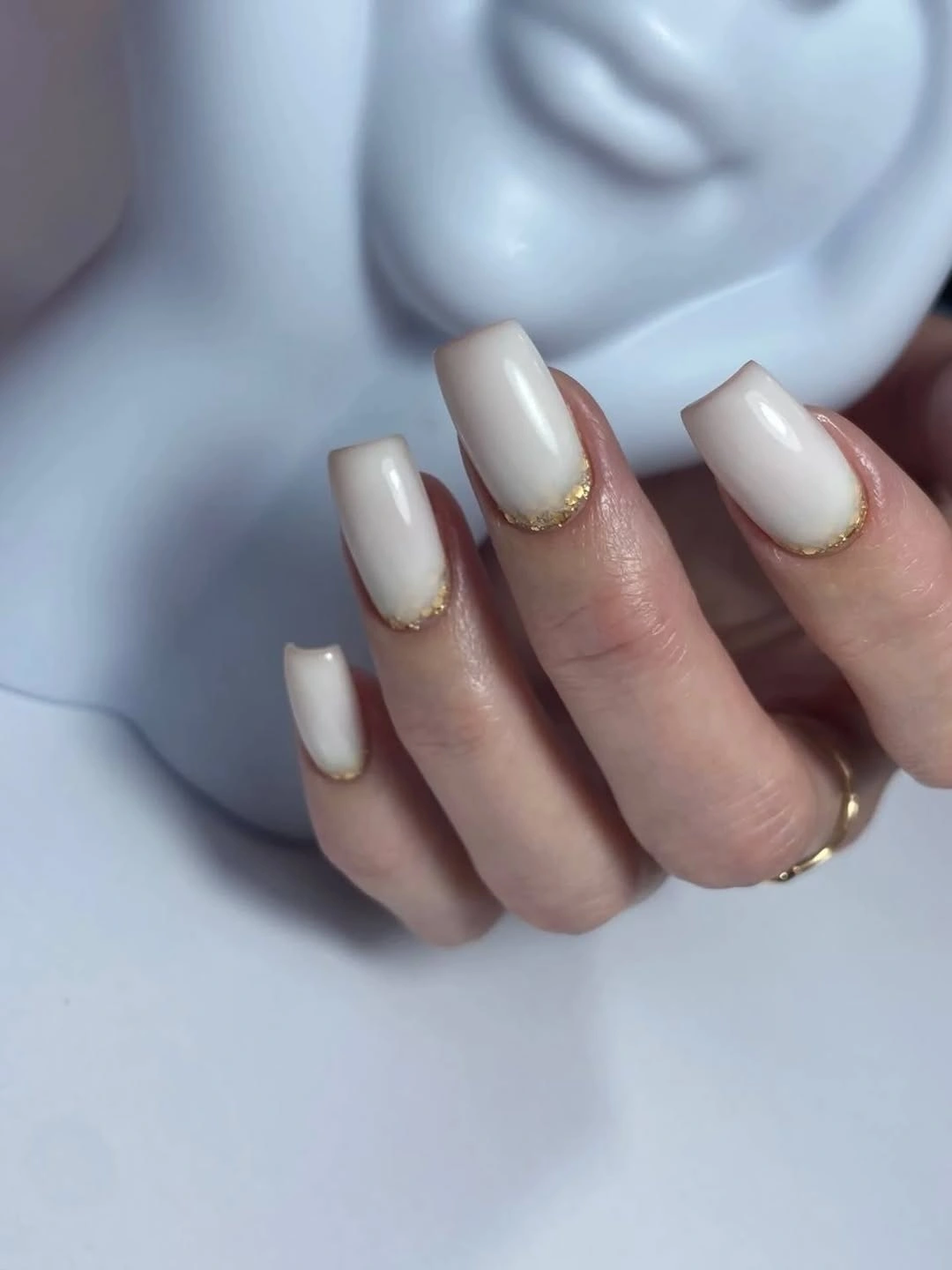 Short square milky white nails with fine warm shimmer