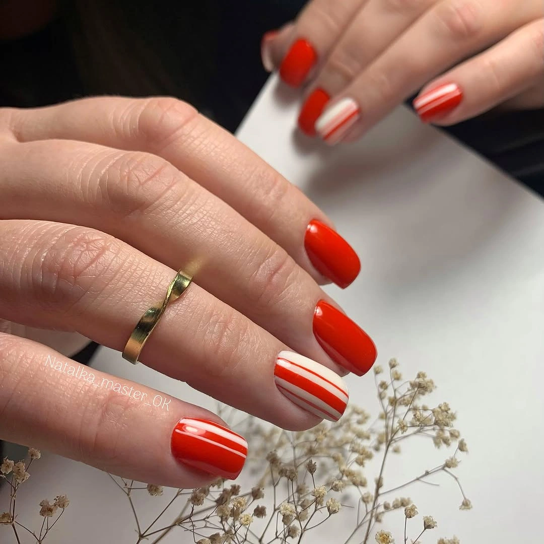 Medium square red orange nails with thin white accents