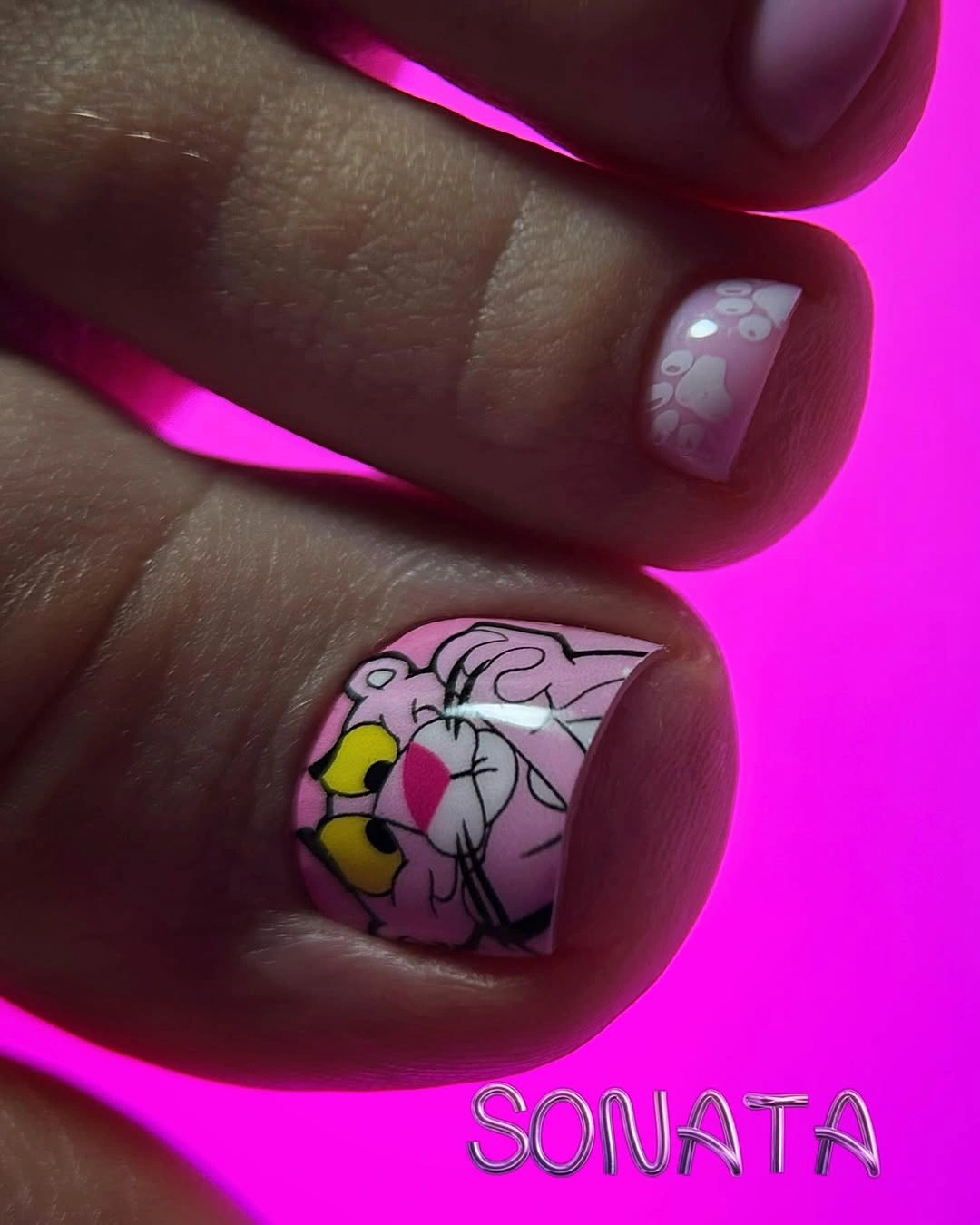 Pale pink toenails with colorful cartoon floral big-toe art