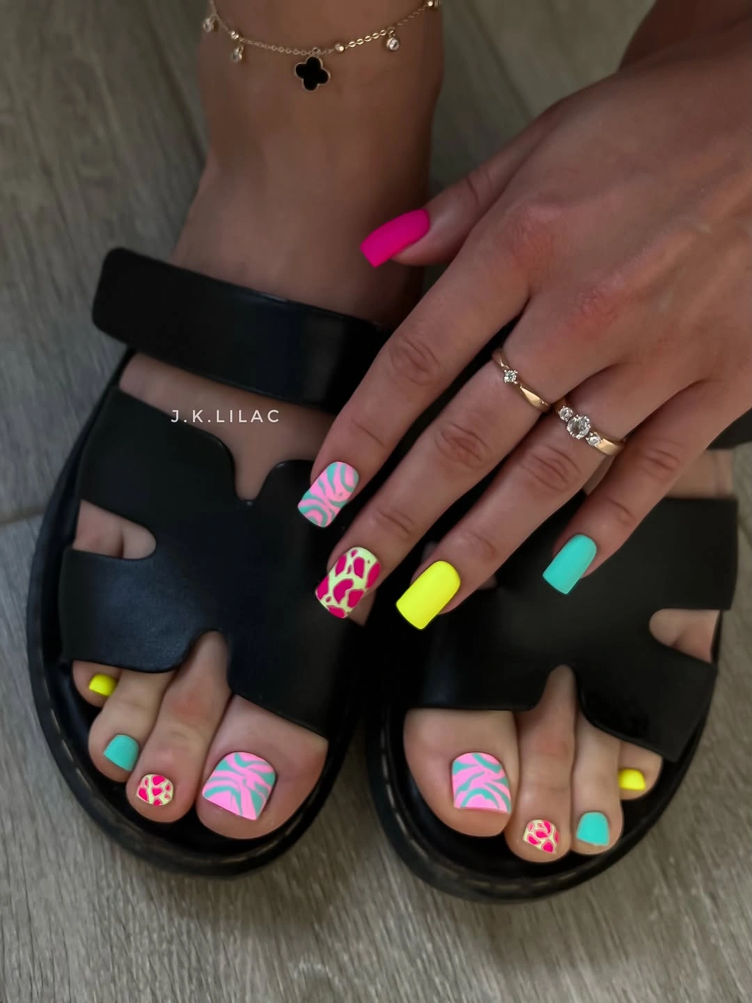 Neon multicolor toes with playful big-toe art in black sandals