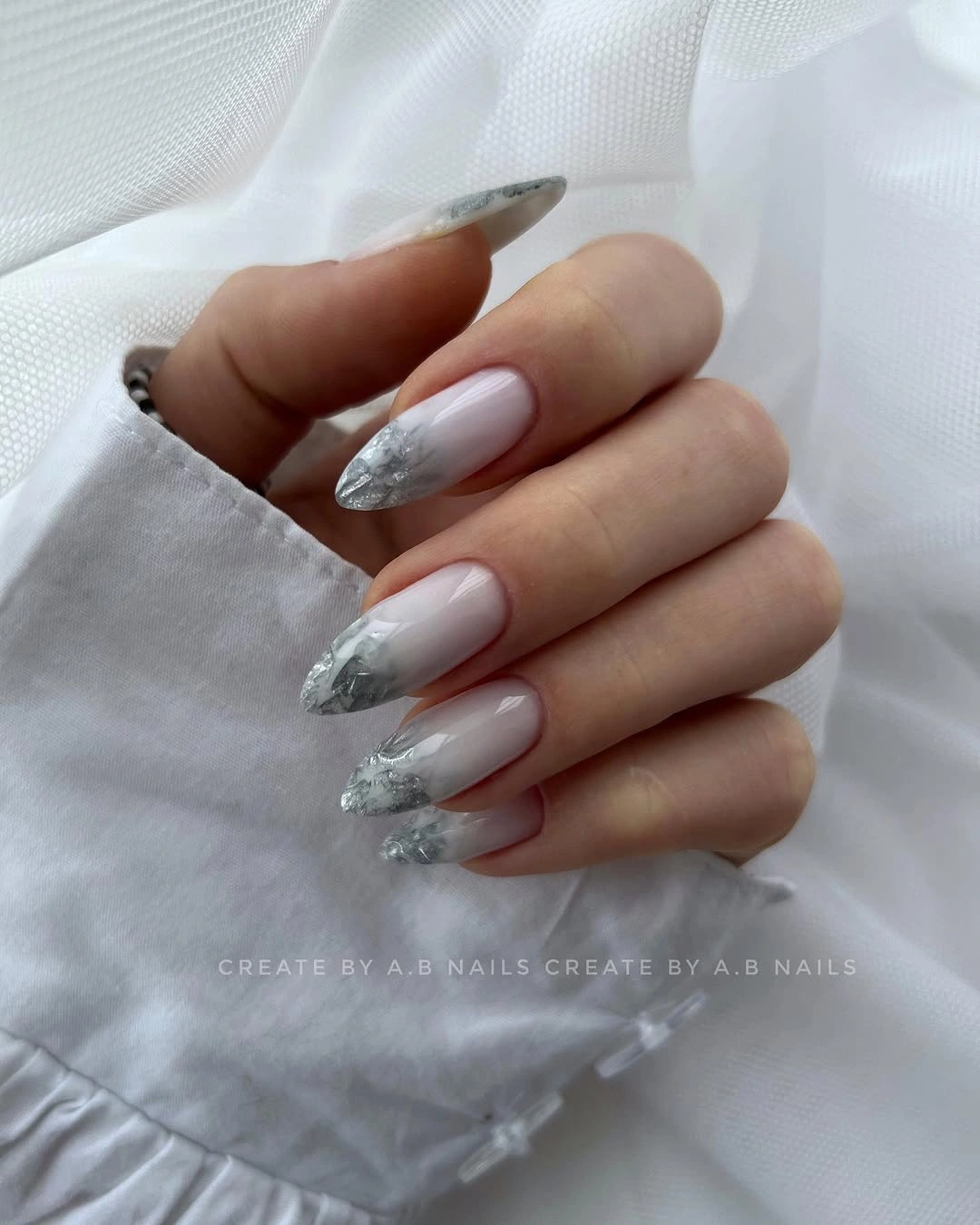 Short milky nails with narrow reflective silver tips