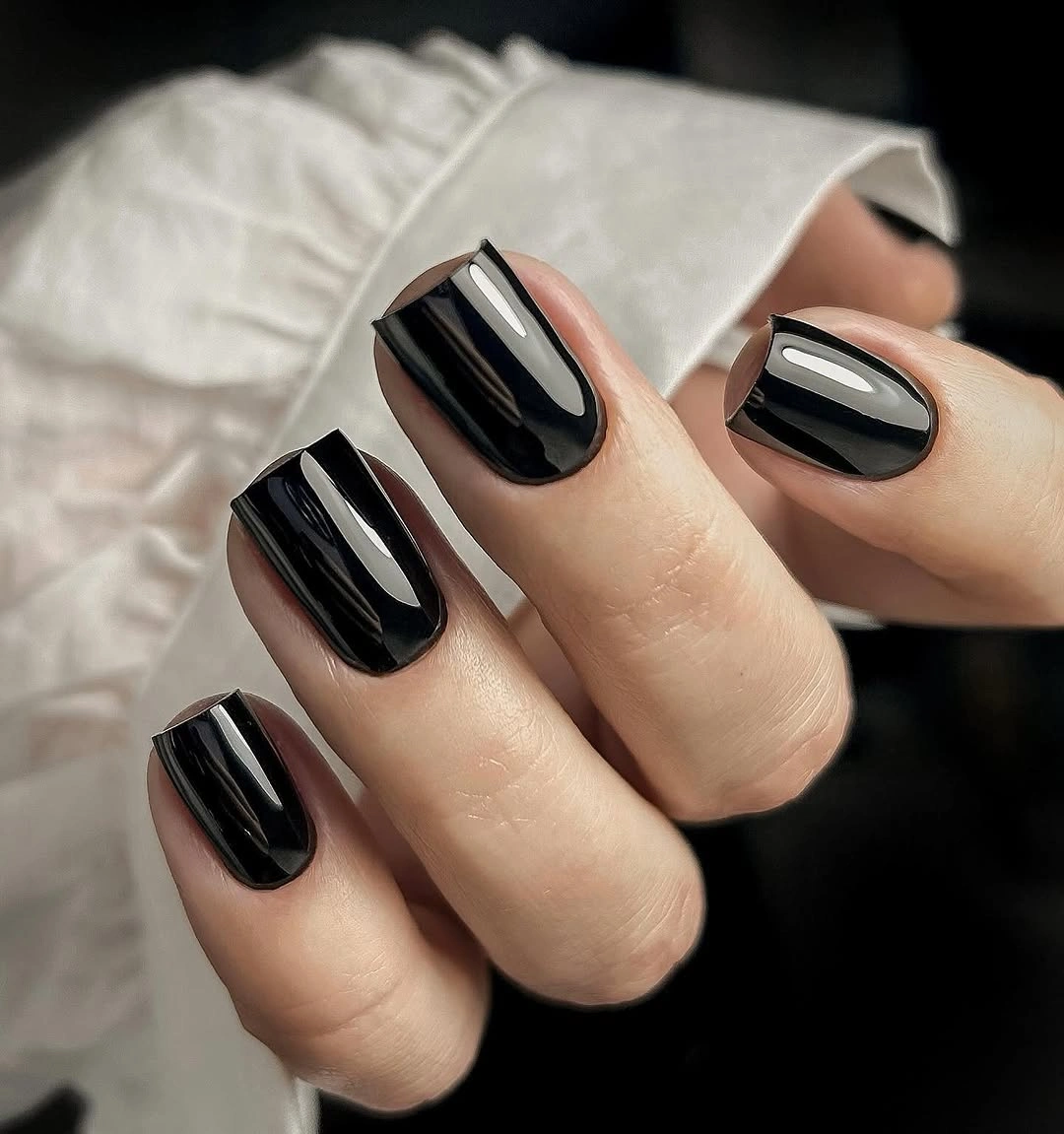 Short nude nails with blue tips and silver accent lines