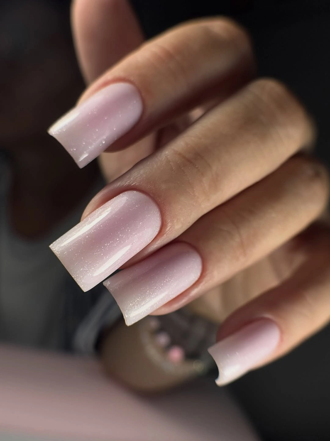 Short glossy black nails with strong white reflected highlights