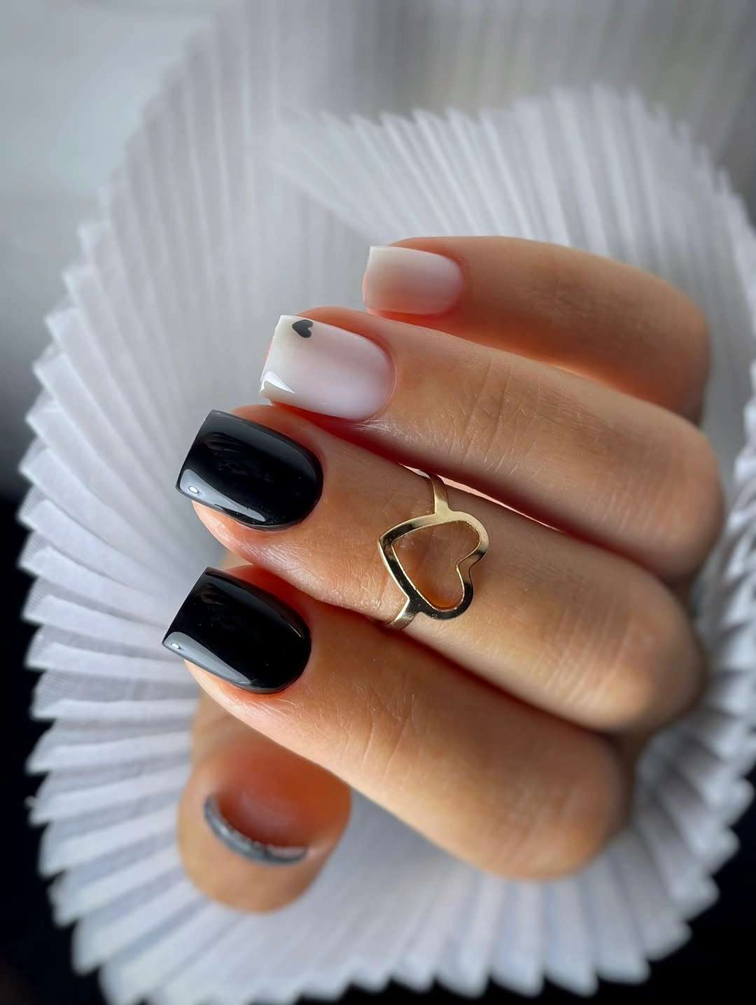 Short pale square nails with black French tips and heart detail