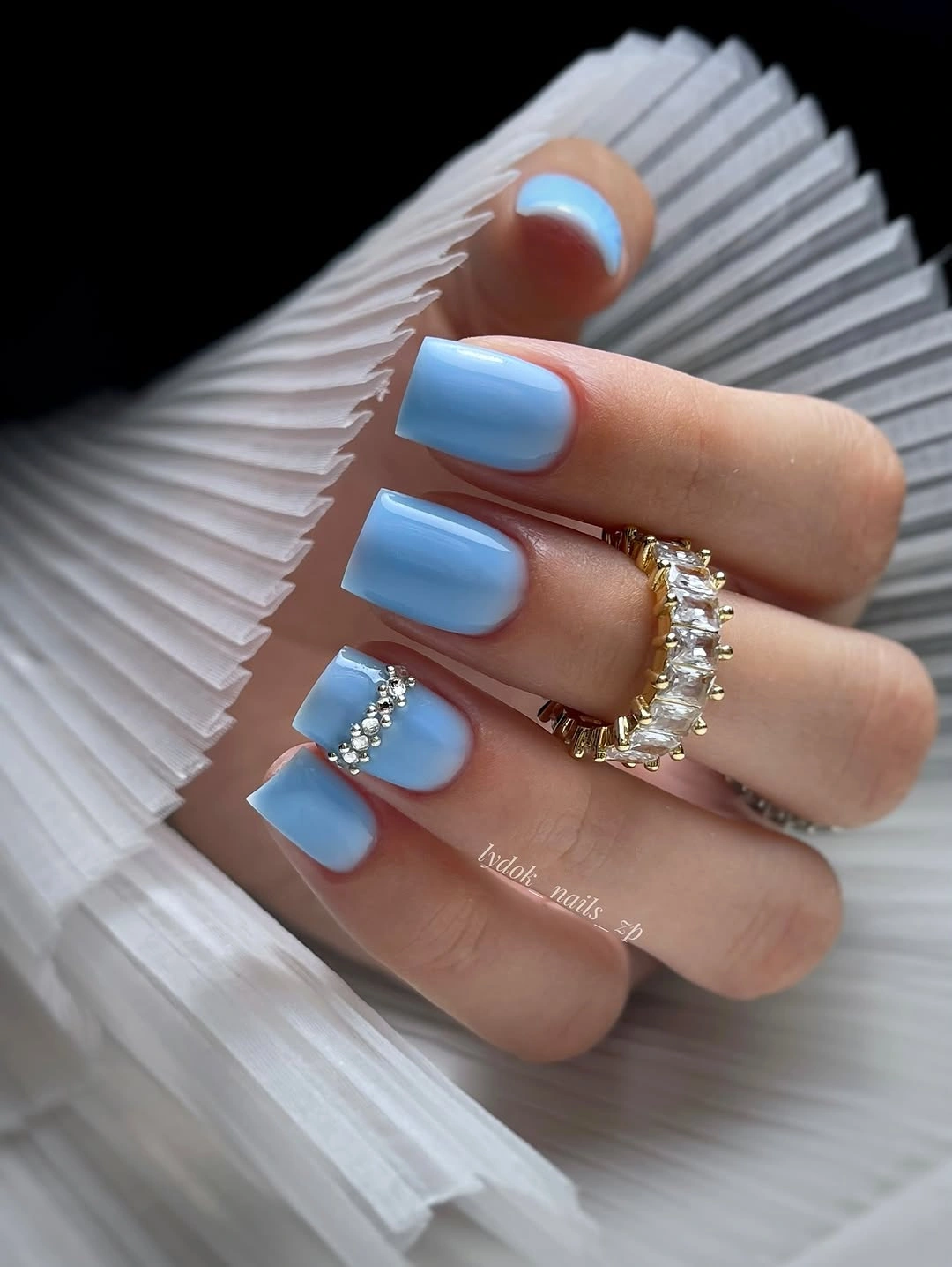 Short glossy light blue square nails with cuticle rhinestones
