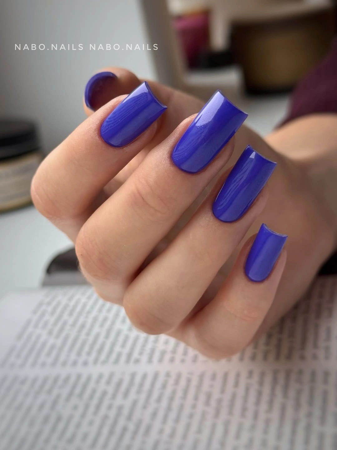 Medium-long glossy blue-violet square nails in solid color
