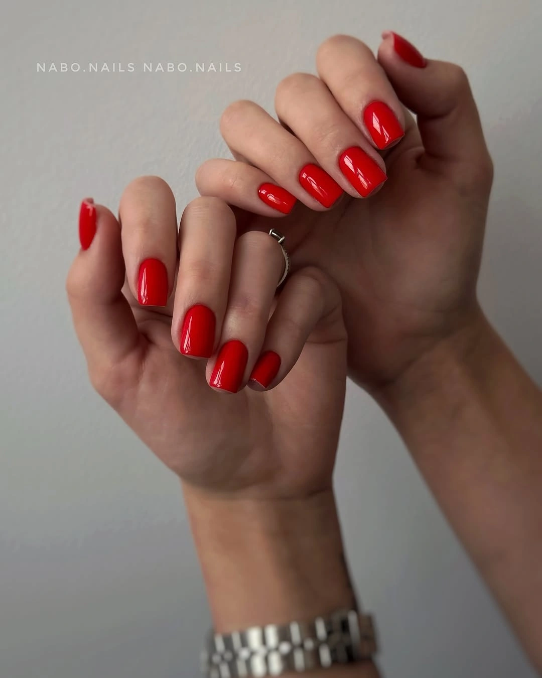 Short glossy cherry red rounded-square nails