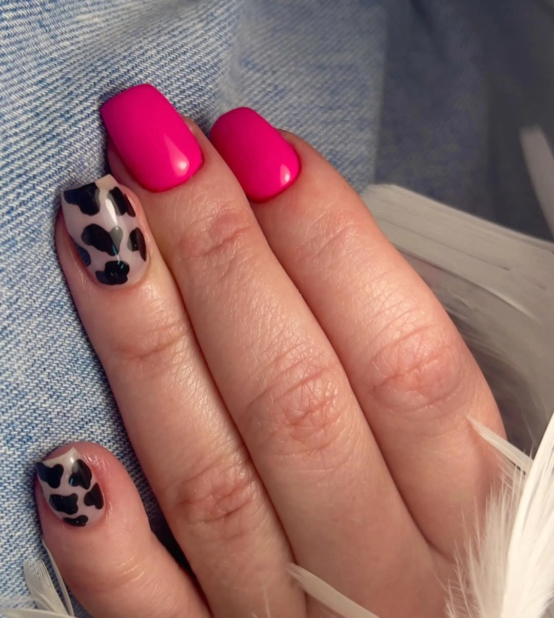 Short hot pink nails with black spotted accent details
